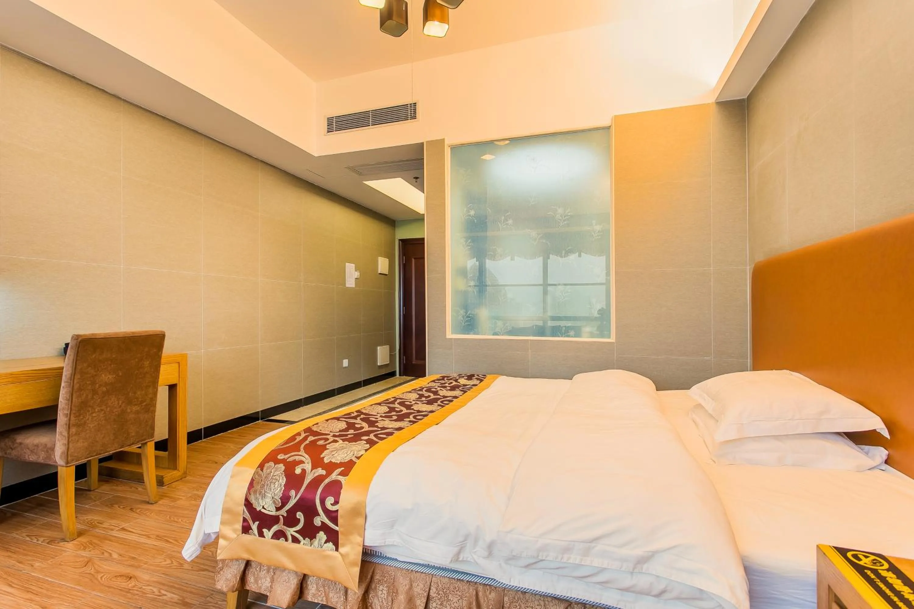 Bed in Grand Continental Apartment