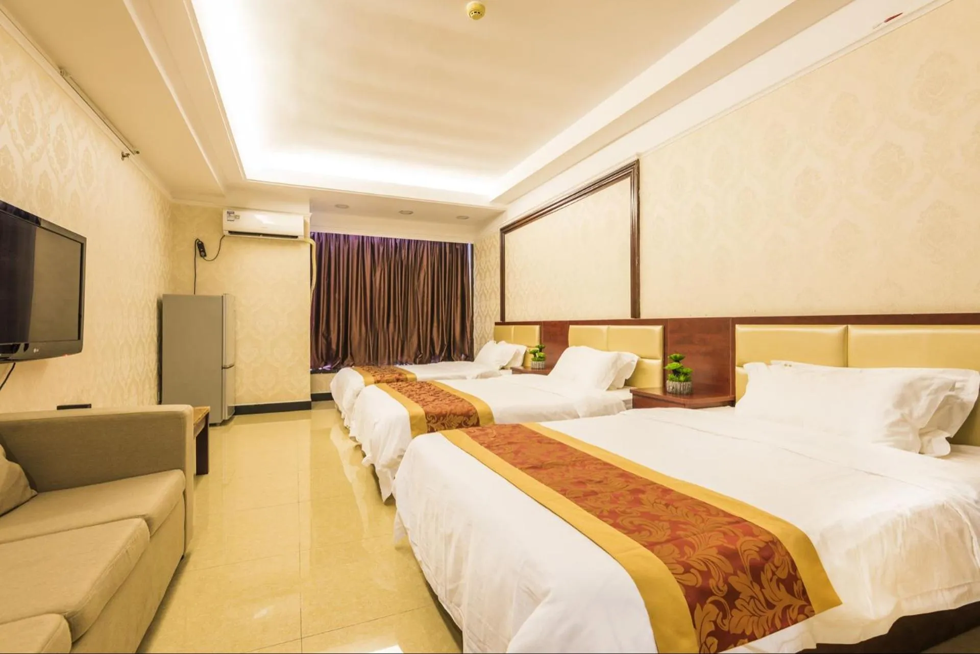 Bed in Grand Continental Apartment