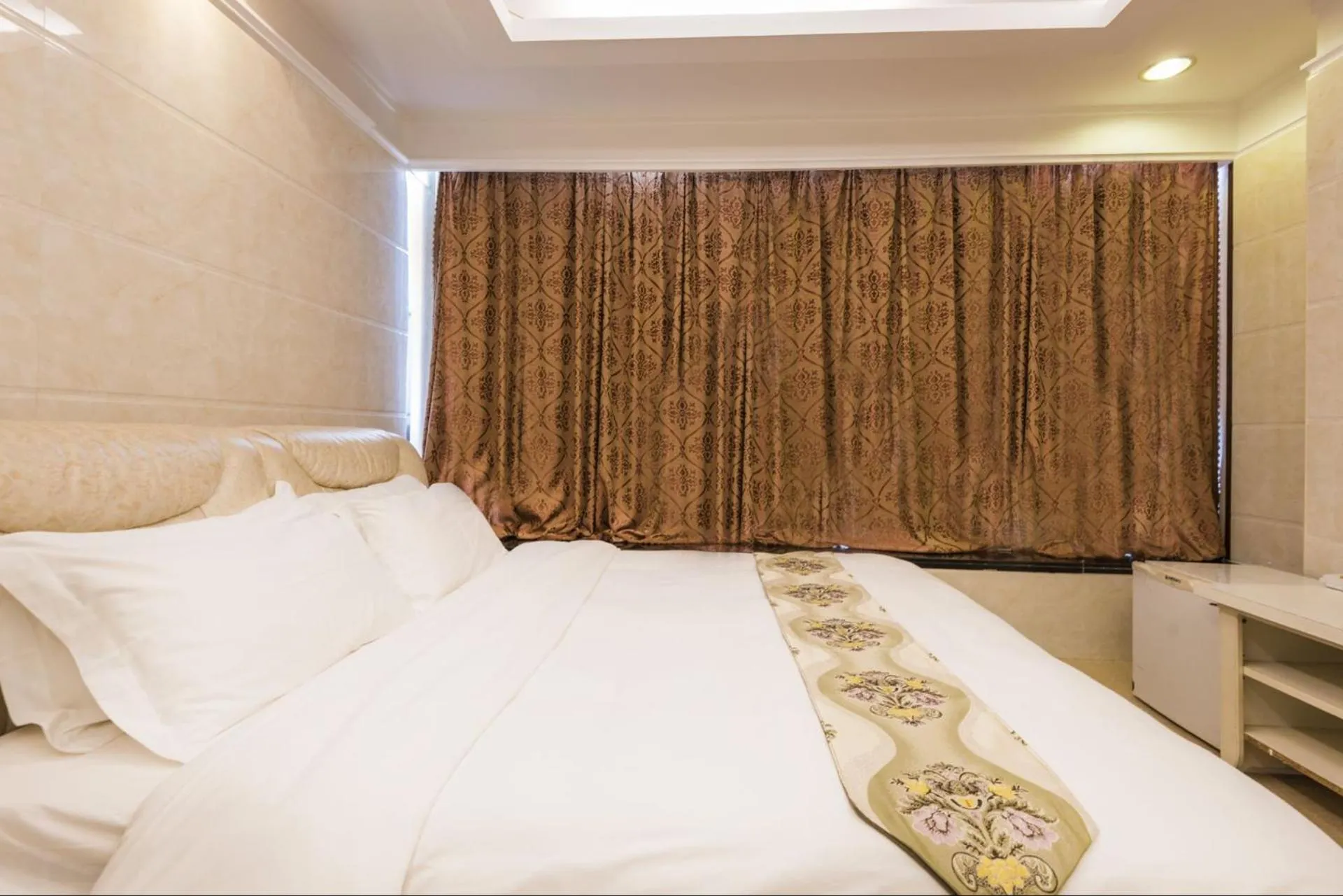 Bed in Grand Continental Apartment