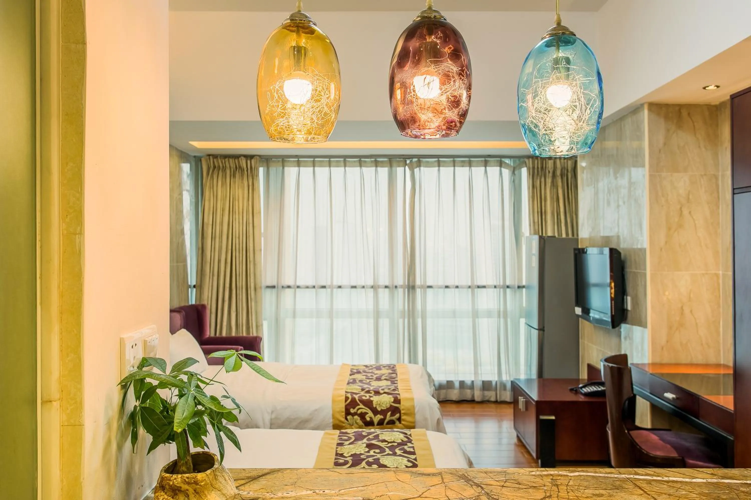 Bed in Grand Continental Apartment