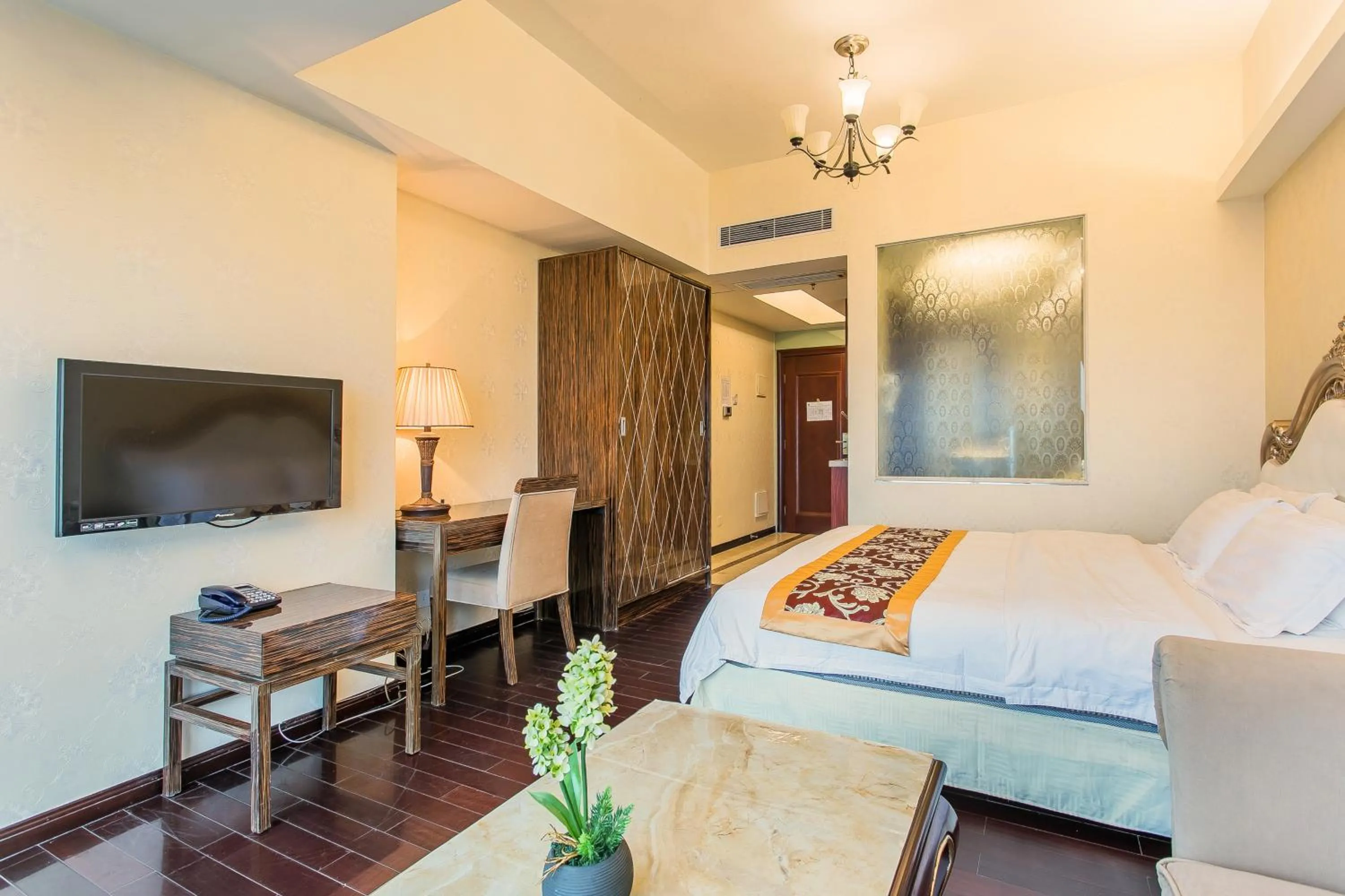 Bed in Grand Continental Apartment