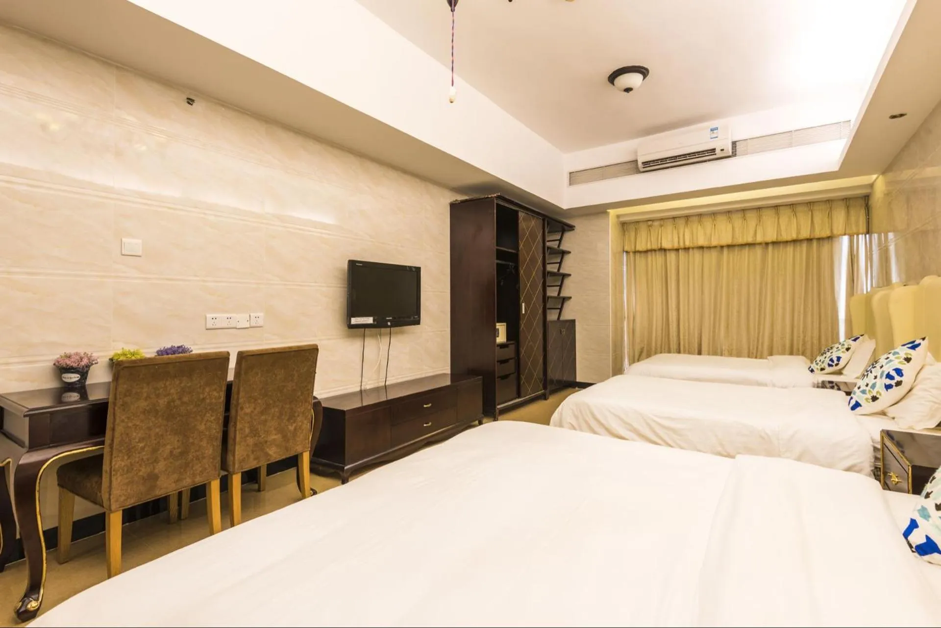 Bed in Grand Continental Apartment