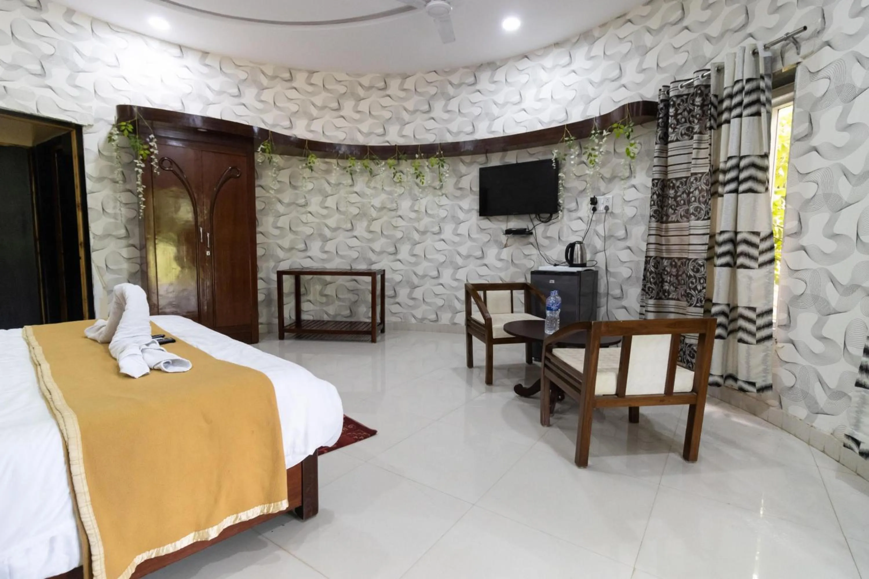 Seating area, Bed in Vrindavan Gopala Resort