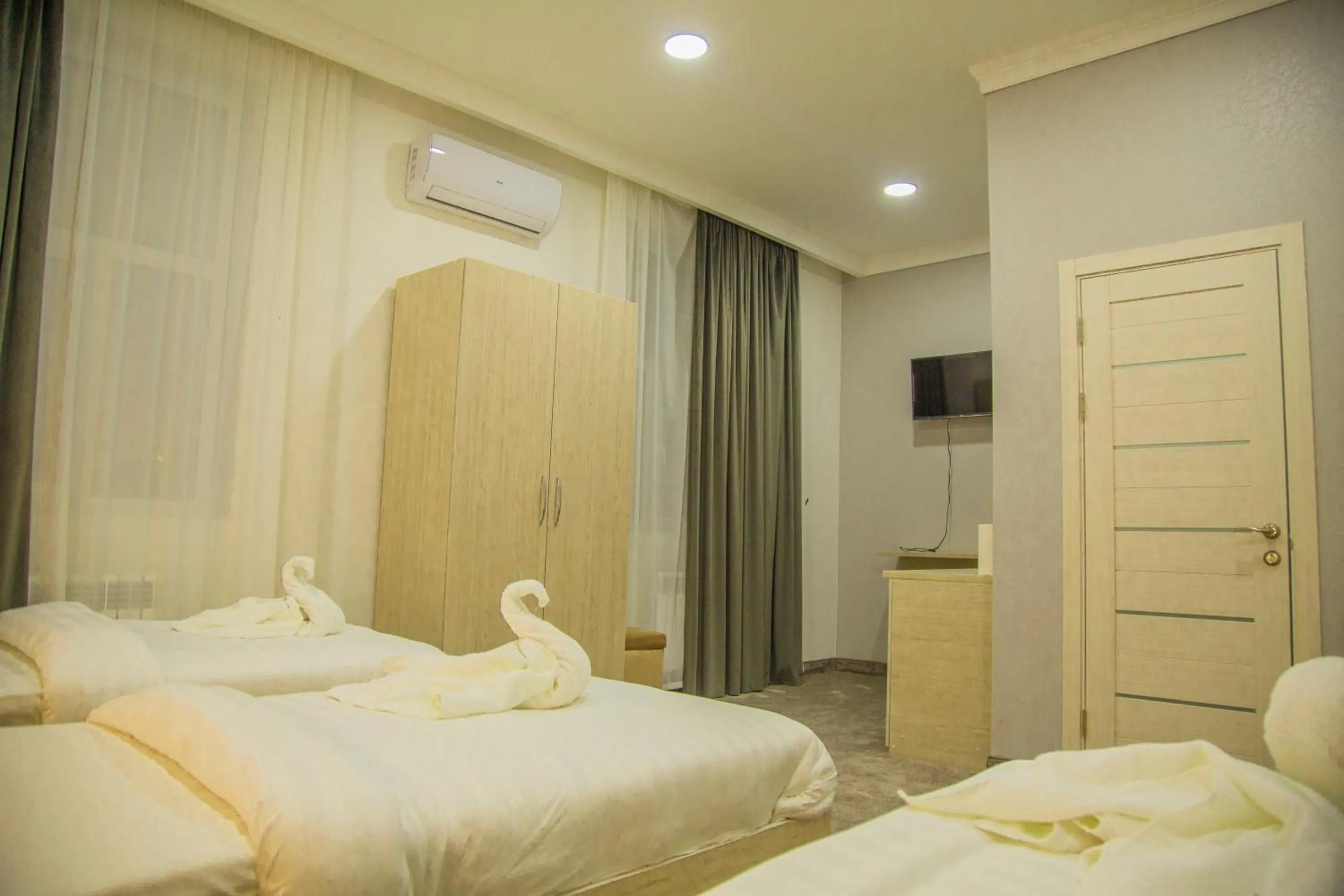 Communal lounge/ TV room, Bed in South Hotel Tashkent