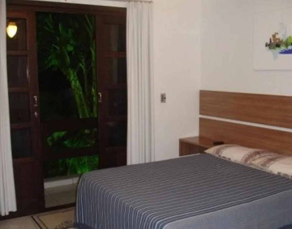 Bed in Pousada Guaruja