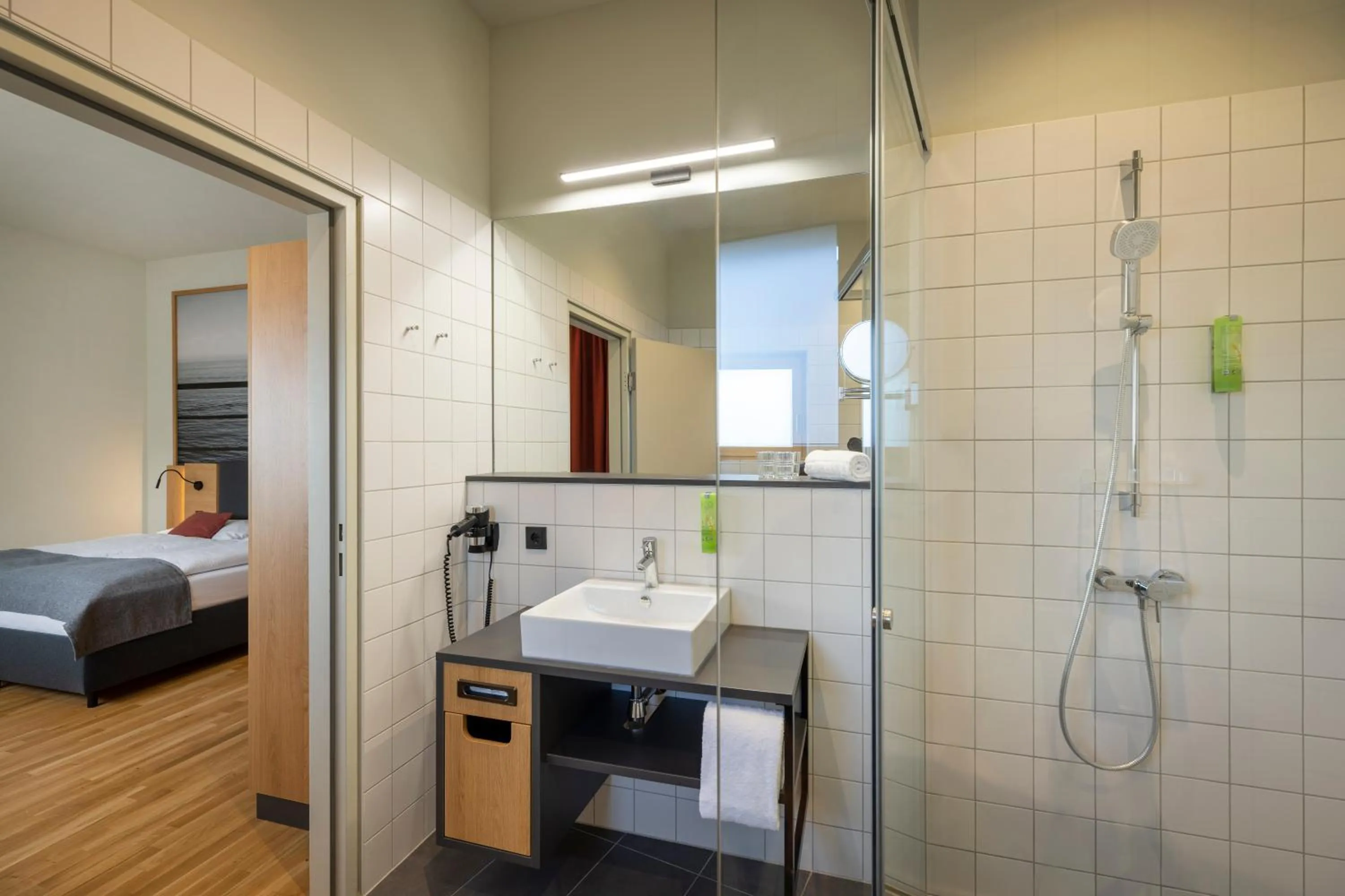 Bathroom, Bed in JUFA Hotel Bregenz