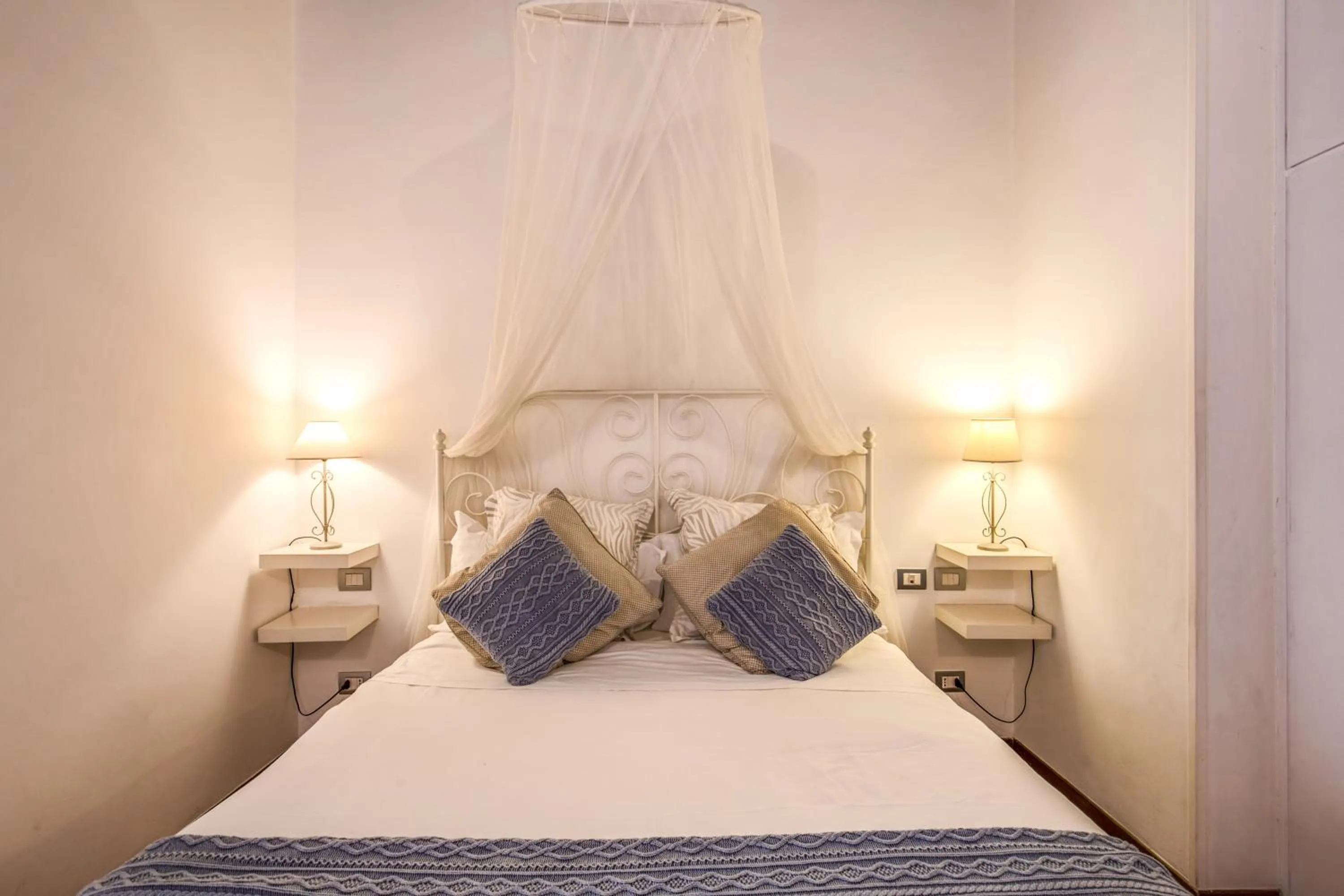 Bed in Elegant Apartment Behind the Colosseum