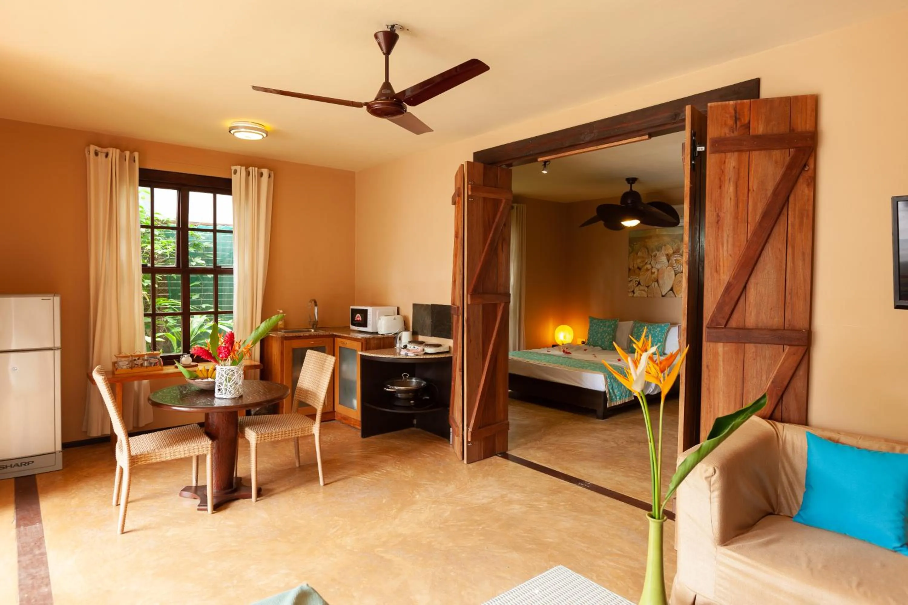 Kitchen or kitchenette, Bed in Villas des Alizes beachfront suites and garden villas