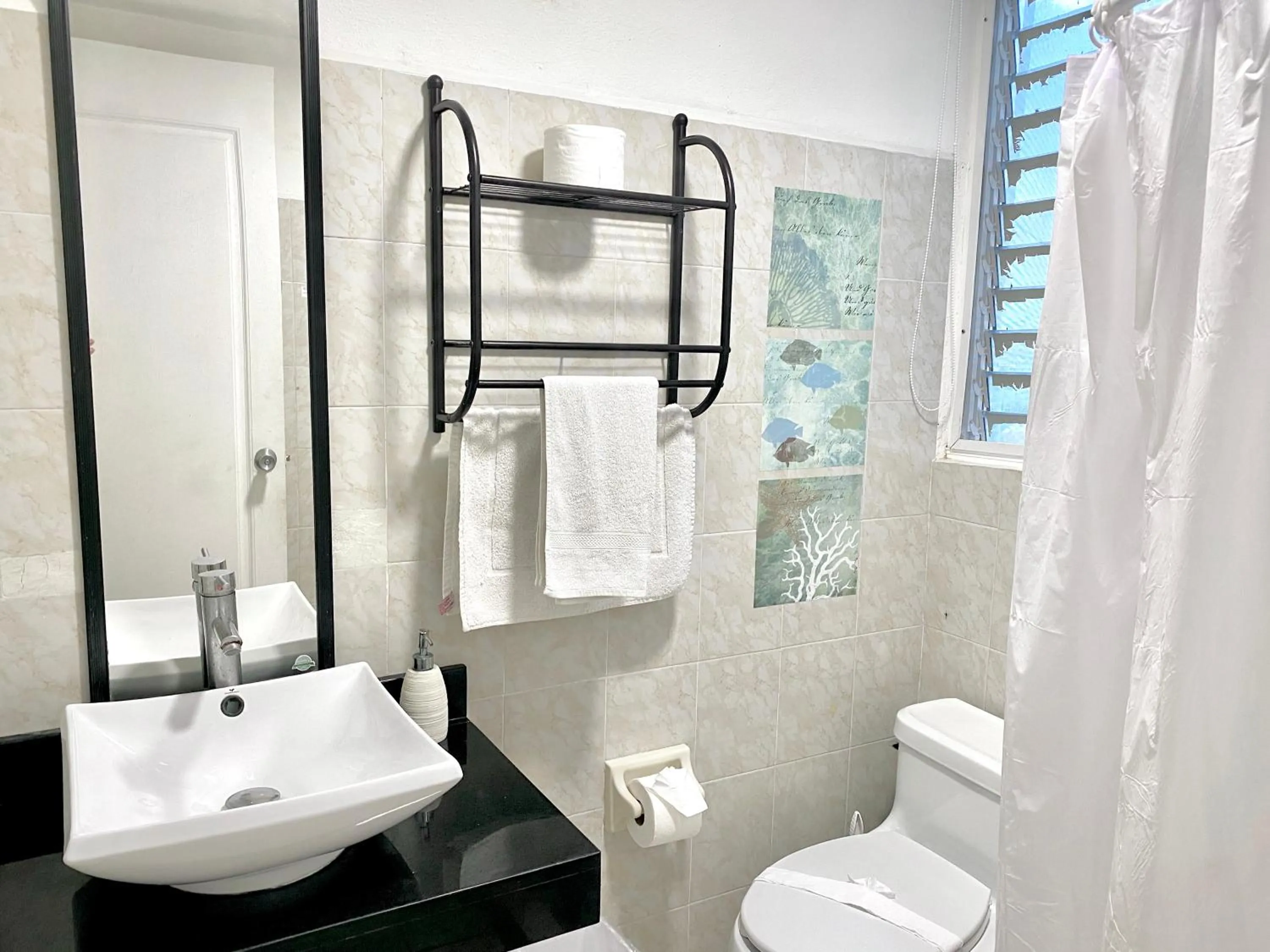 Bathroom in Coco Suites by Andiani Travel