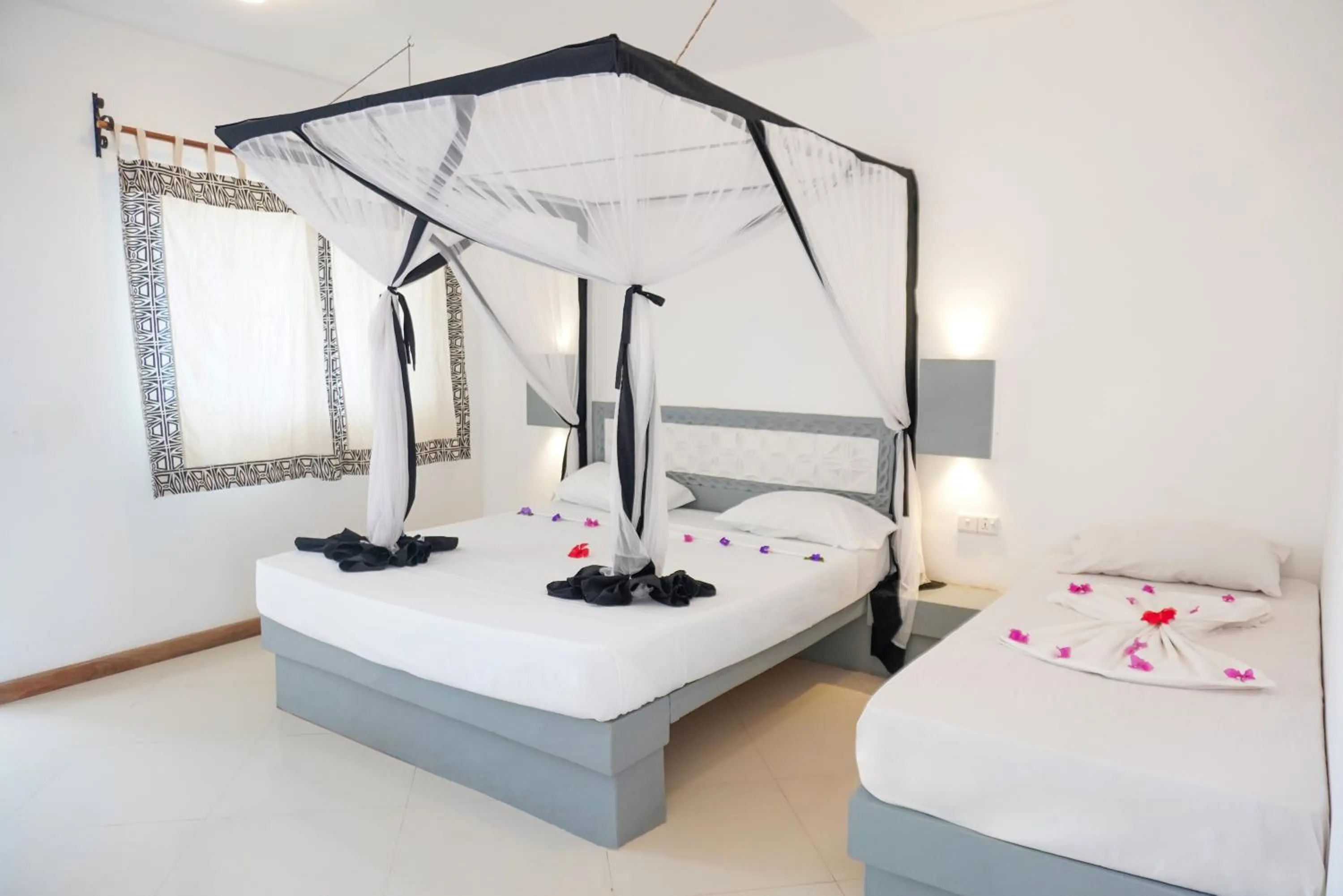 Bed in AHG Sun Bay Mlilile Beach Hotel