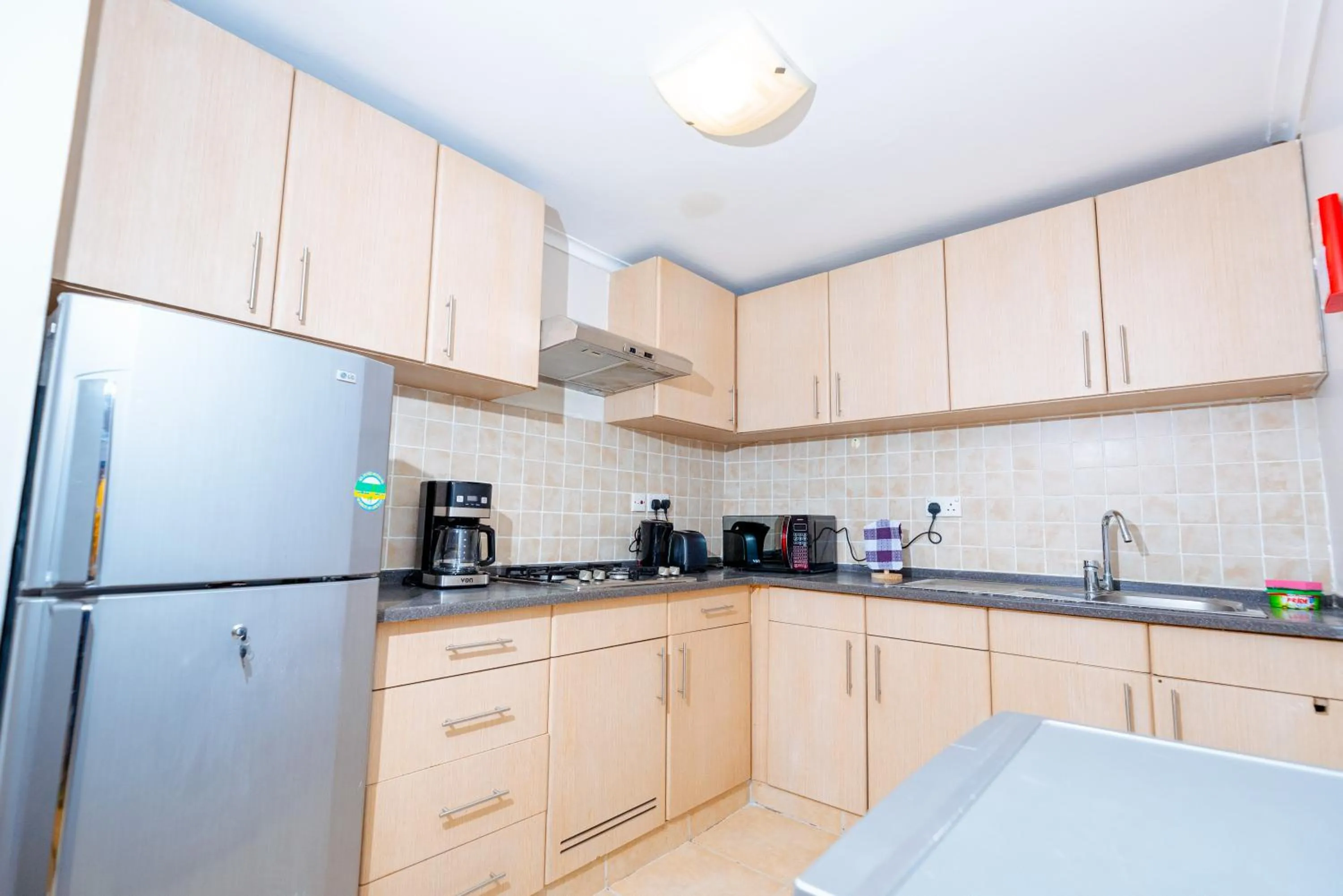 Kitchen or kitchenette in Heri Heights Hotel Apartments, SureStay Collection by Best Western