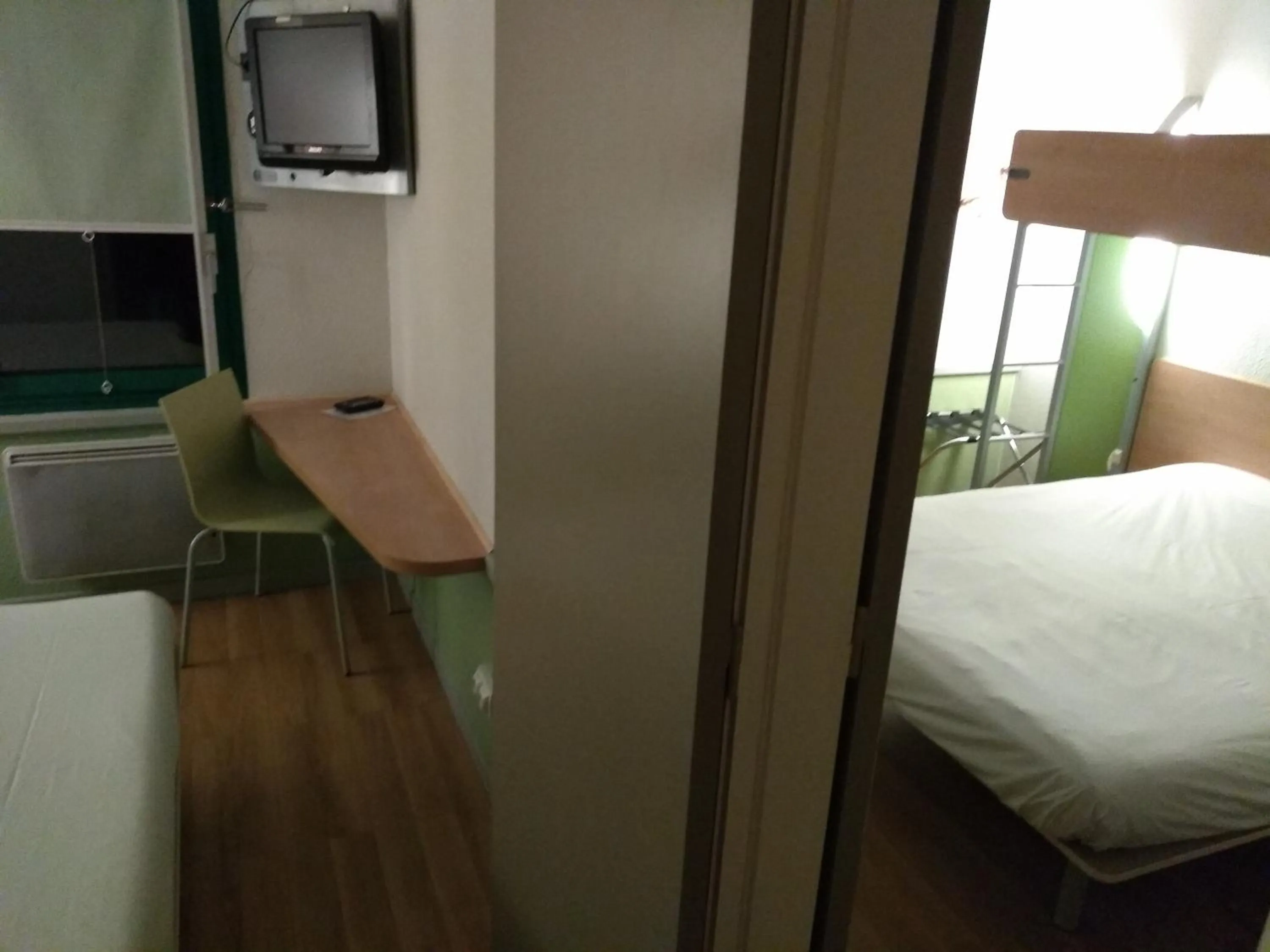 Communal lounge/ TV room, Bed in Hotel Inn Design Laon