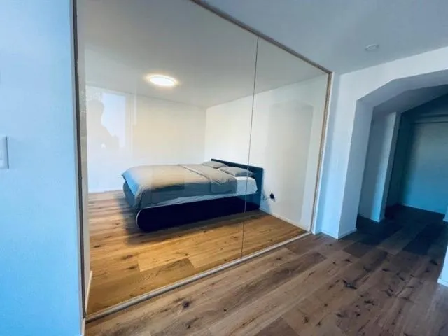 Bed in BERG & BERG APARTMENTS - Spiez Self-Check-in