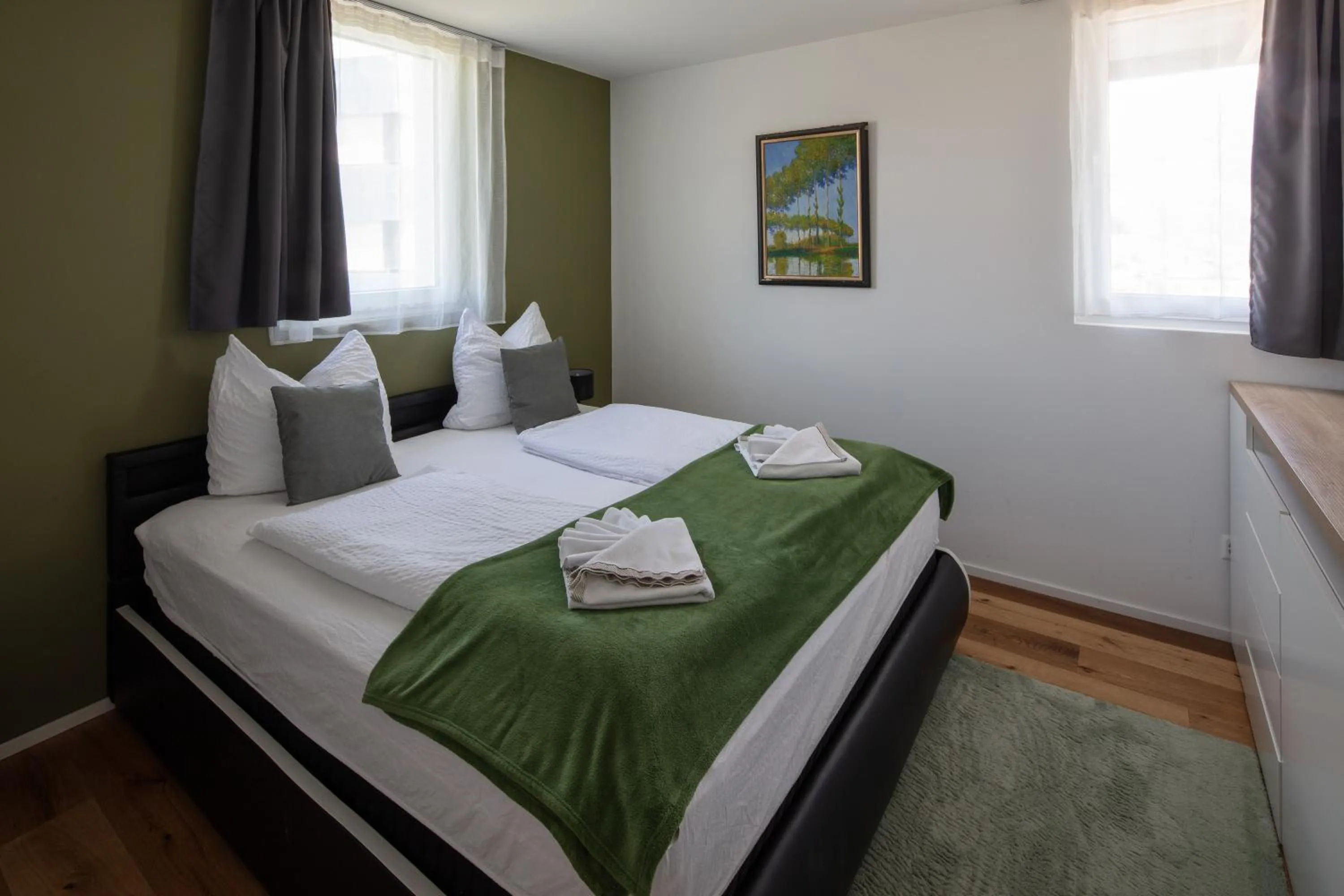 Bed in BERG & BERG APARTMENTS - Spiez Self-Check-in
