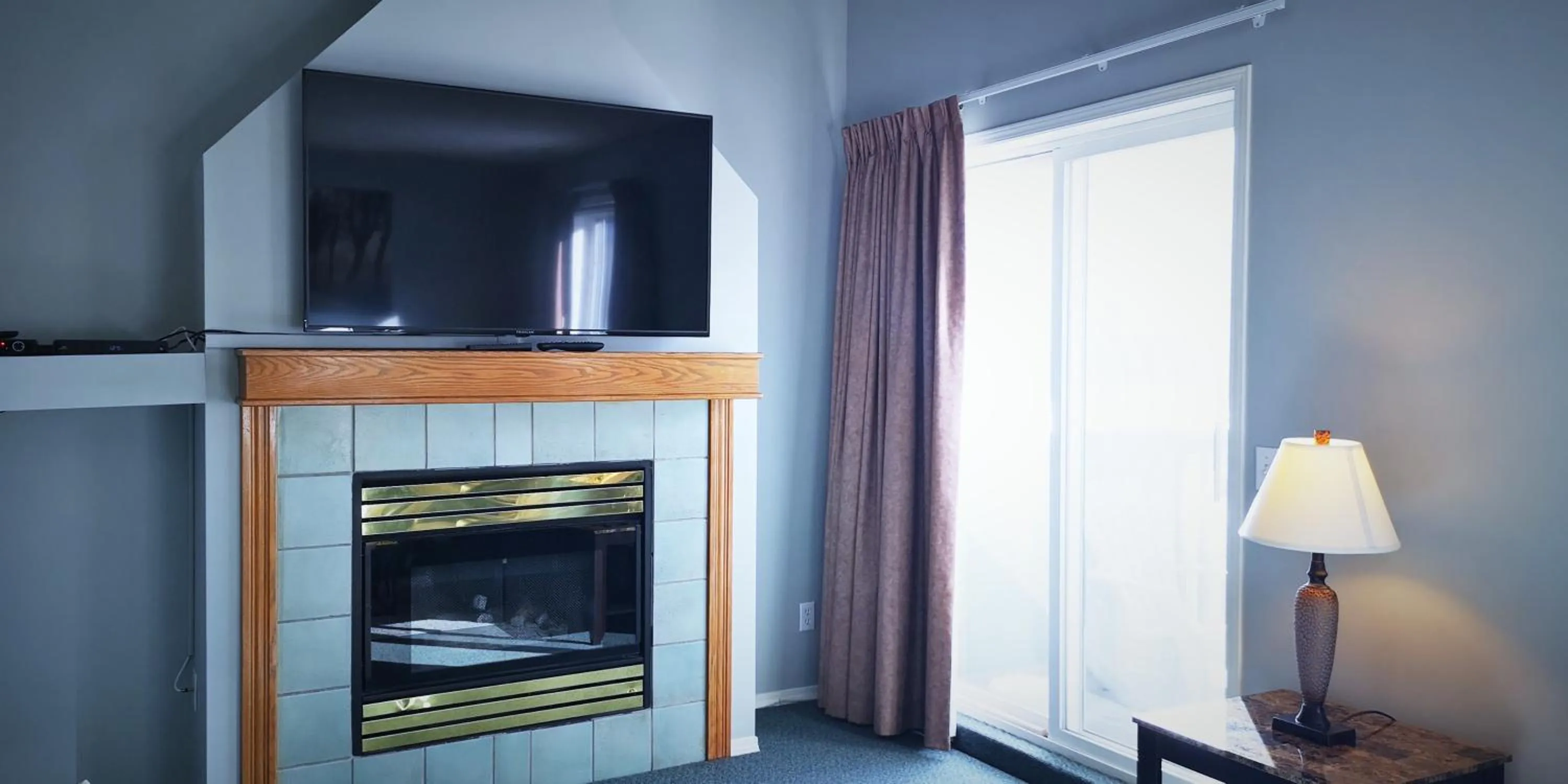 TV and multimedia in Canadian Rockies Chalets by Trilink - 2 & 3 Bedroom Condos - Self Check-In - Walking Distance to Downtown - Free Parking - Pet-Friendly - No AC