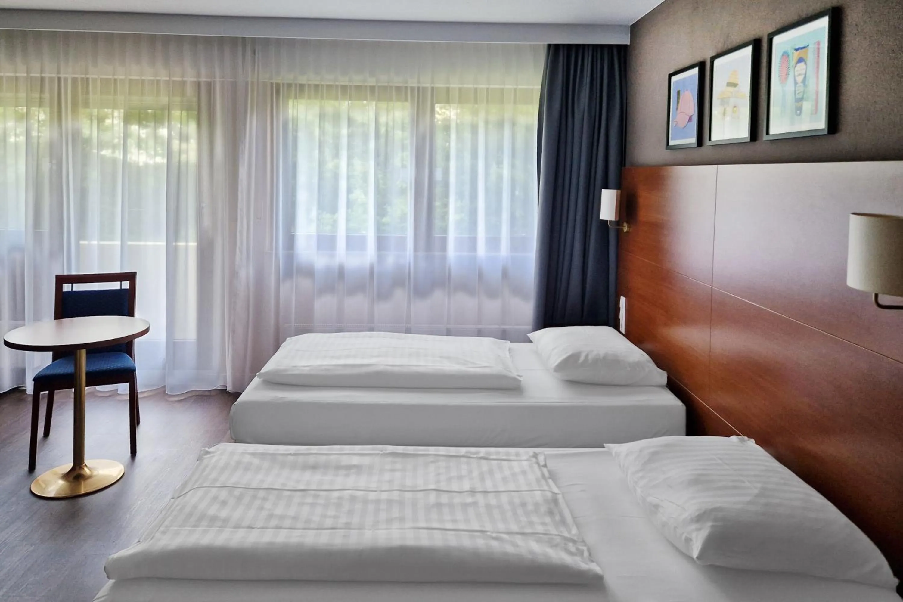 Seating area, Bed in Hotel Rega Stuttgart