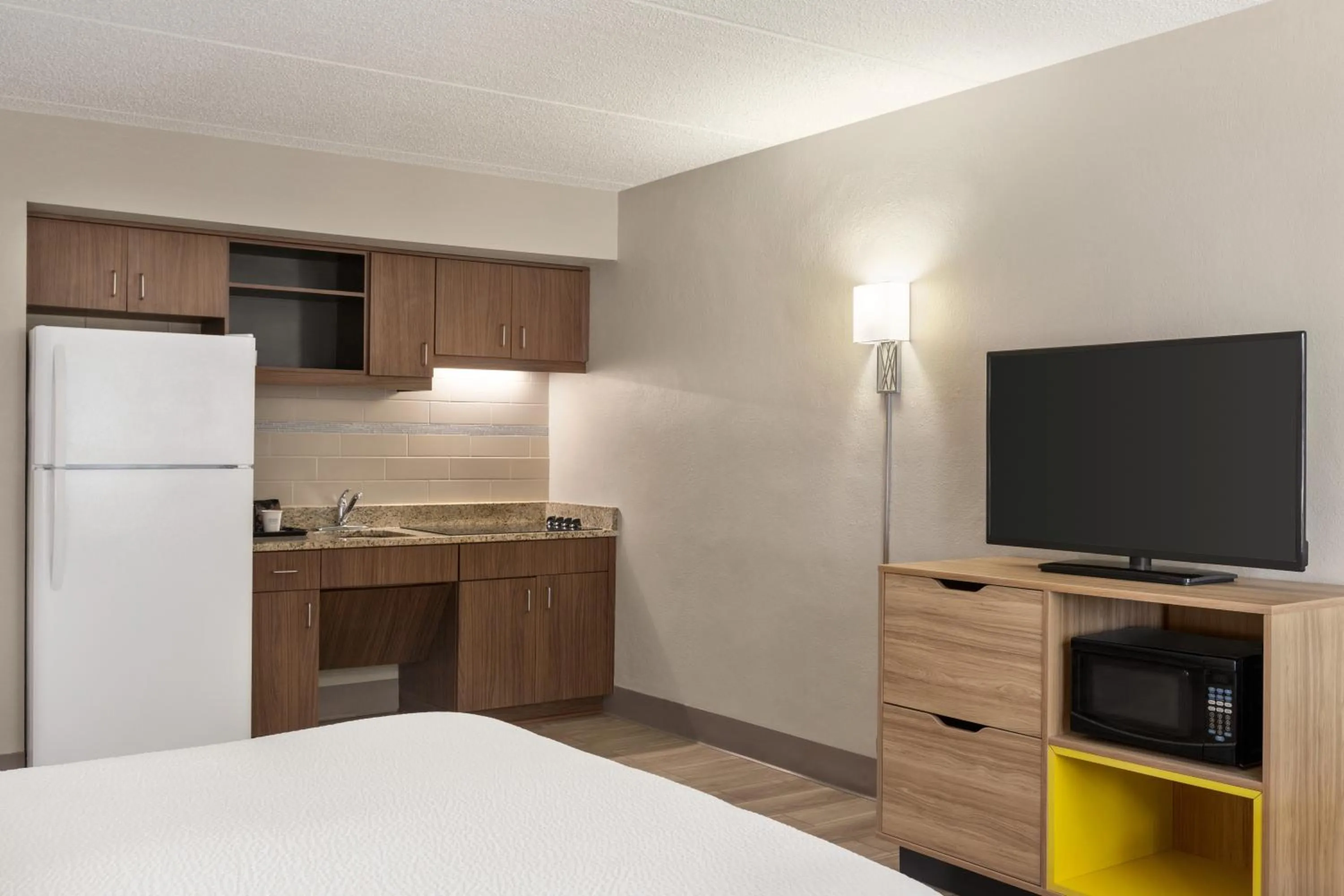 kitchen, Bed in Days Inn by Wyndham Cocoa Beach Port Canaveral