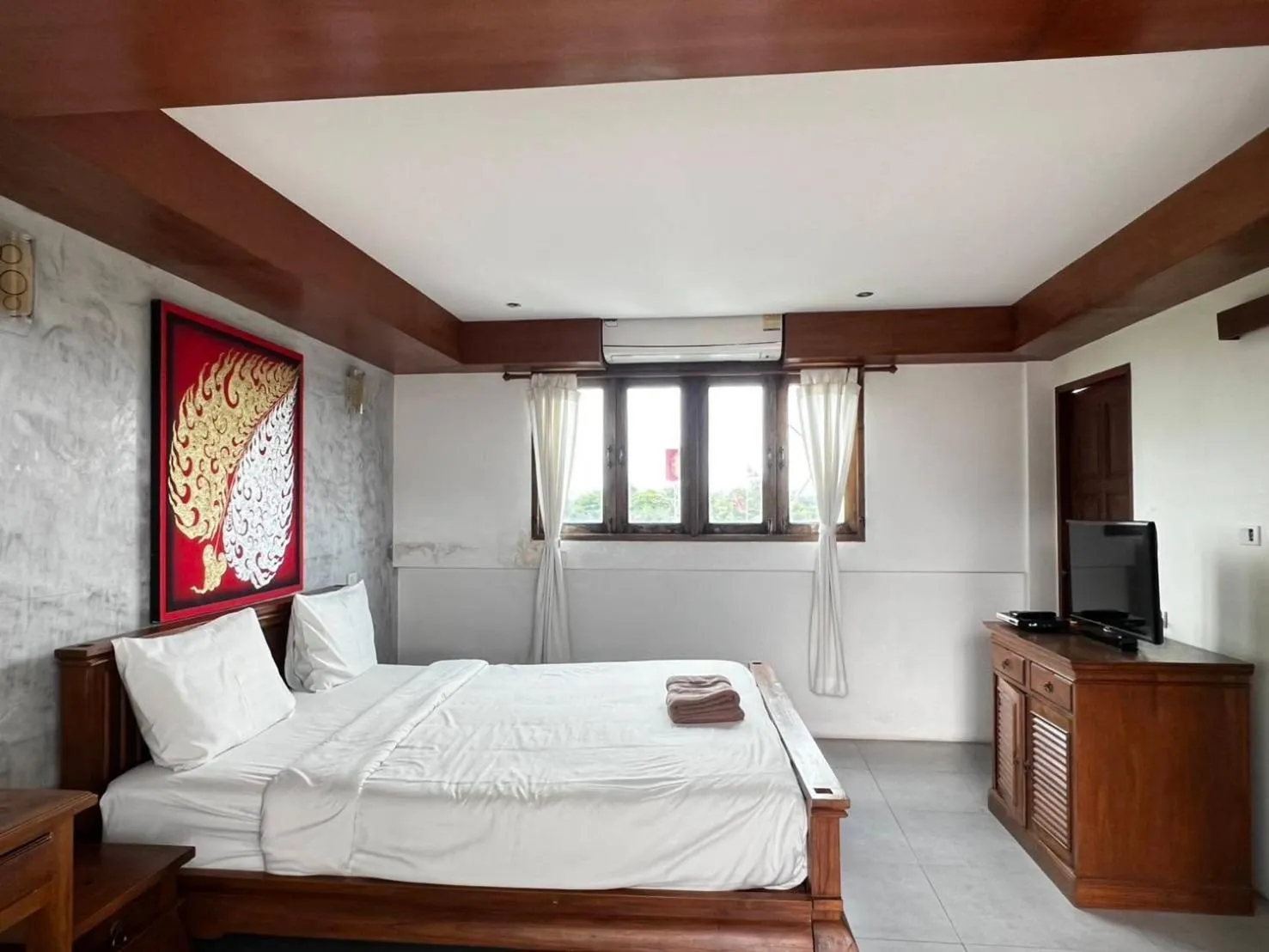 Bed in De Nawarat Chiangmai Boutique Apartment