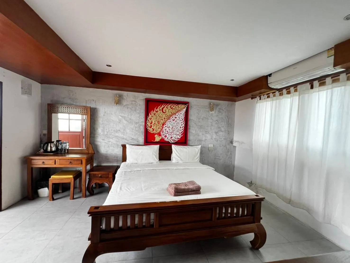 Bed in De Nawarat Chiangmai Boutique Apartment