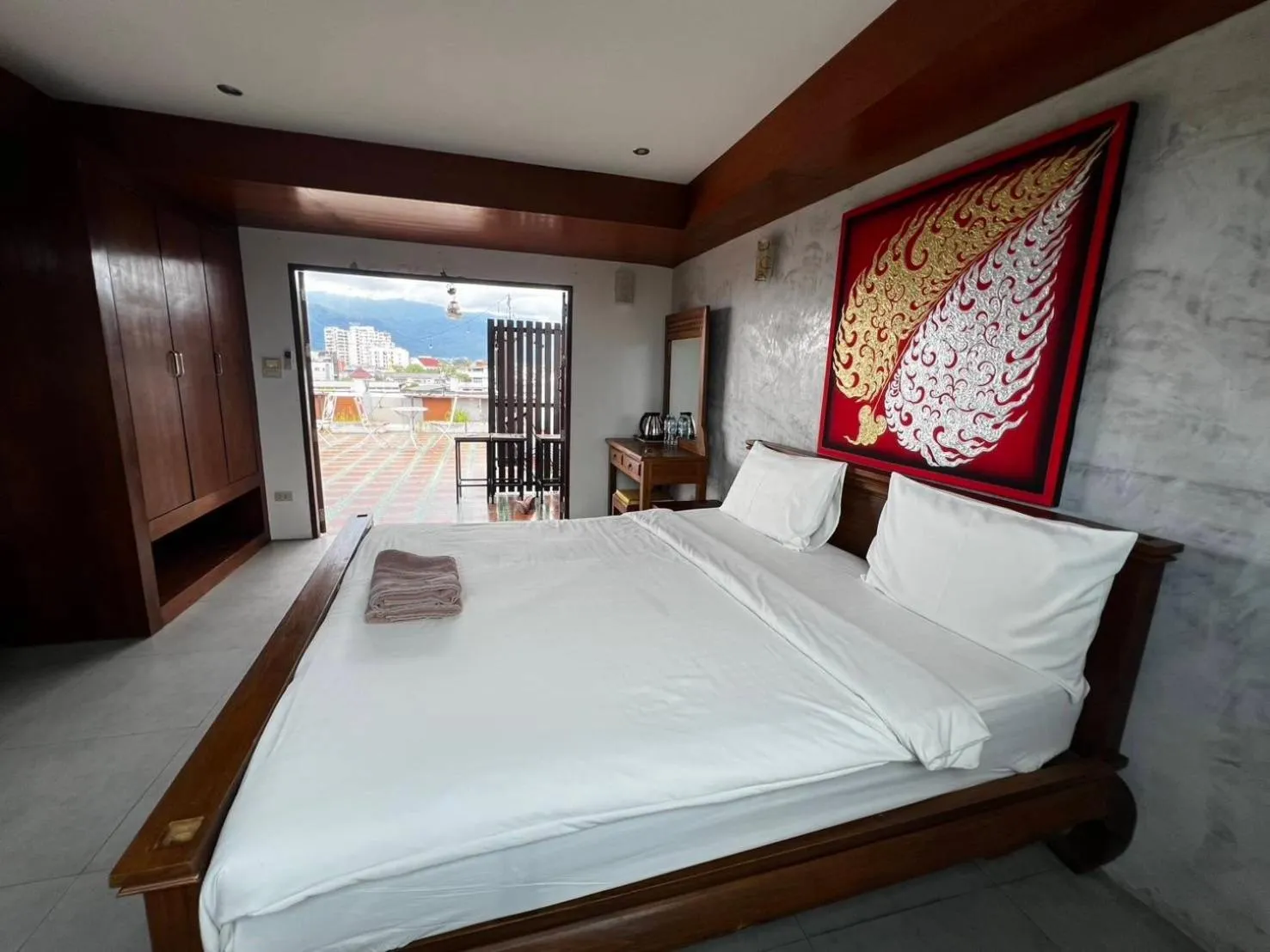 Bed in De Nawarat Chiangmai Boutique Apartment