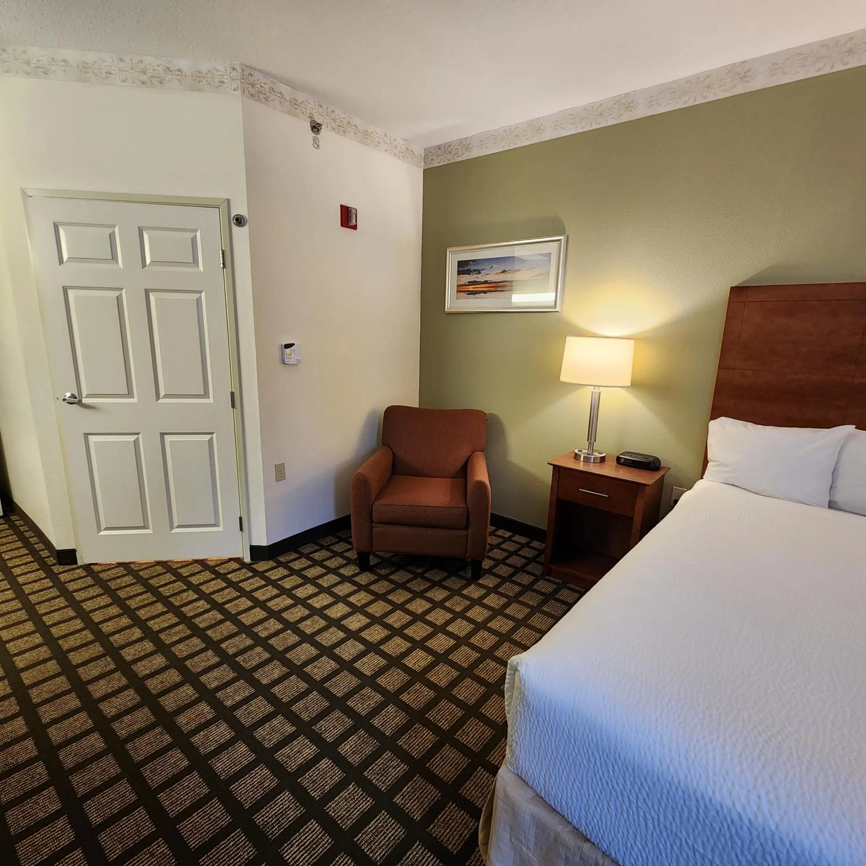 Seating area, Bed in Baymont by Wyndham Mackinaw City