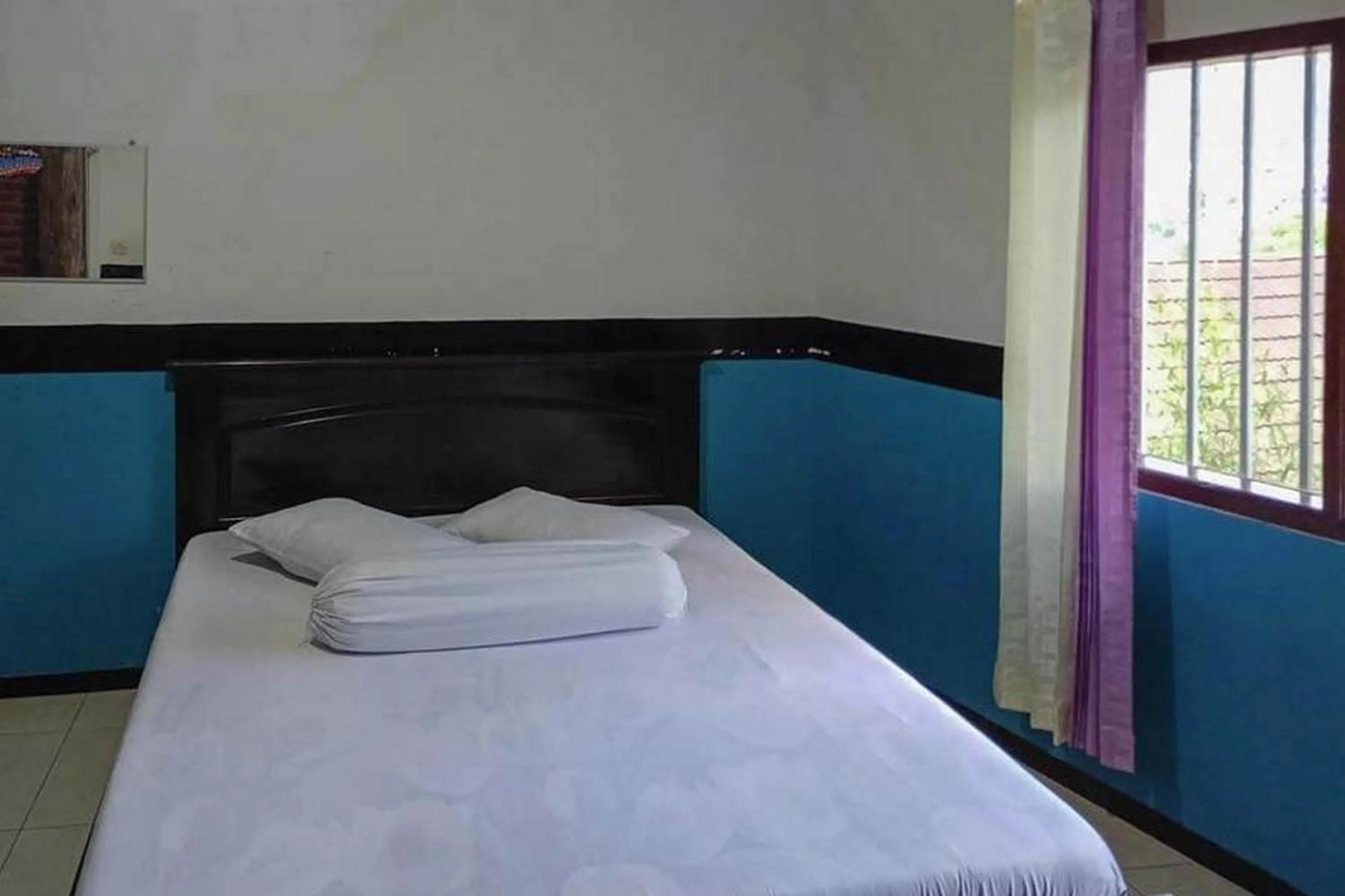 Bed in Villa Ghazani 4 at Desa Wisata Songgokerto