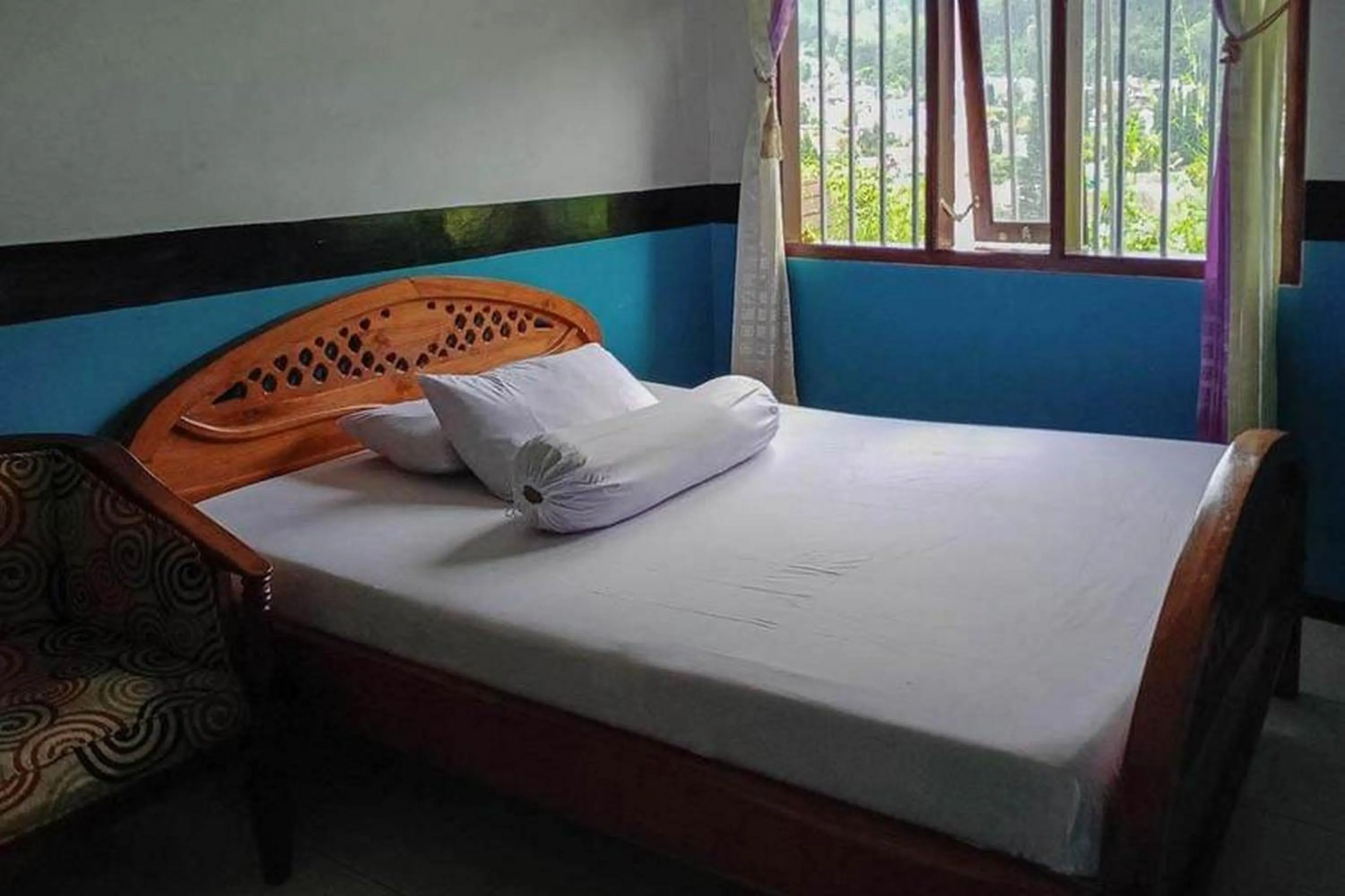 Bed in Villa Ghazani 4 at Desa Wisata Songgokerto