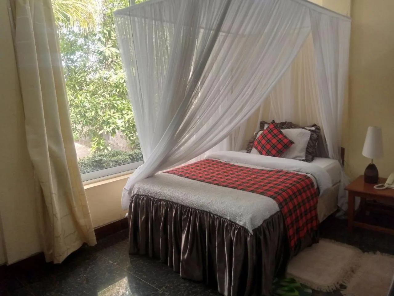 Bed in Karibu Heritage House