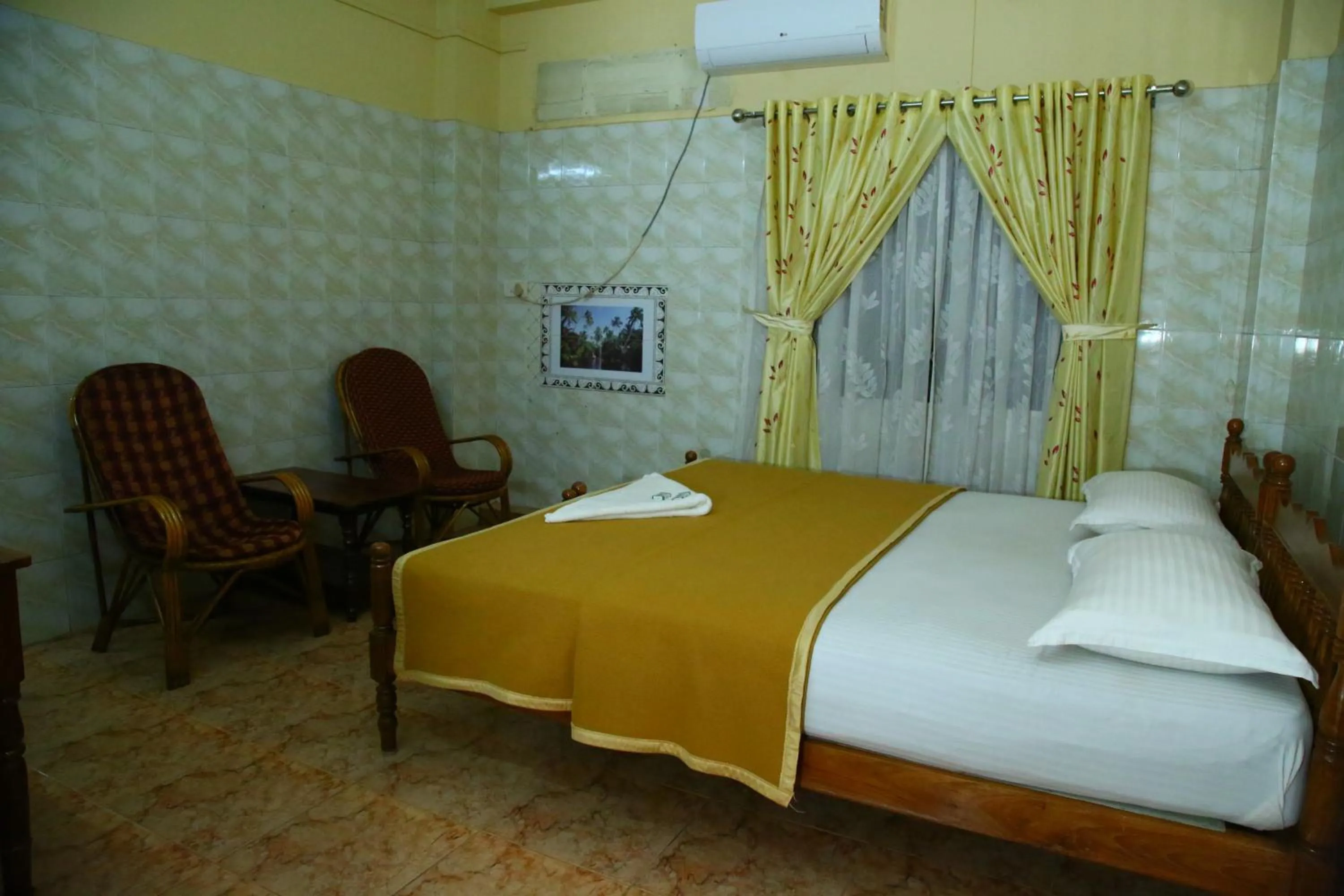 Bed in Lake Palace Family Resort Kumarakom