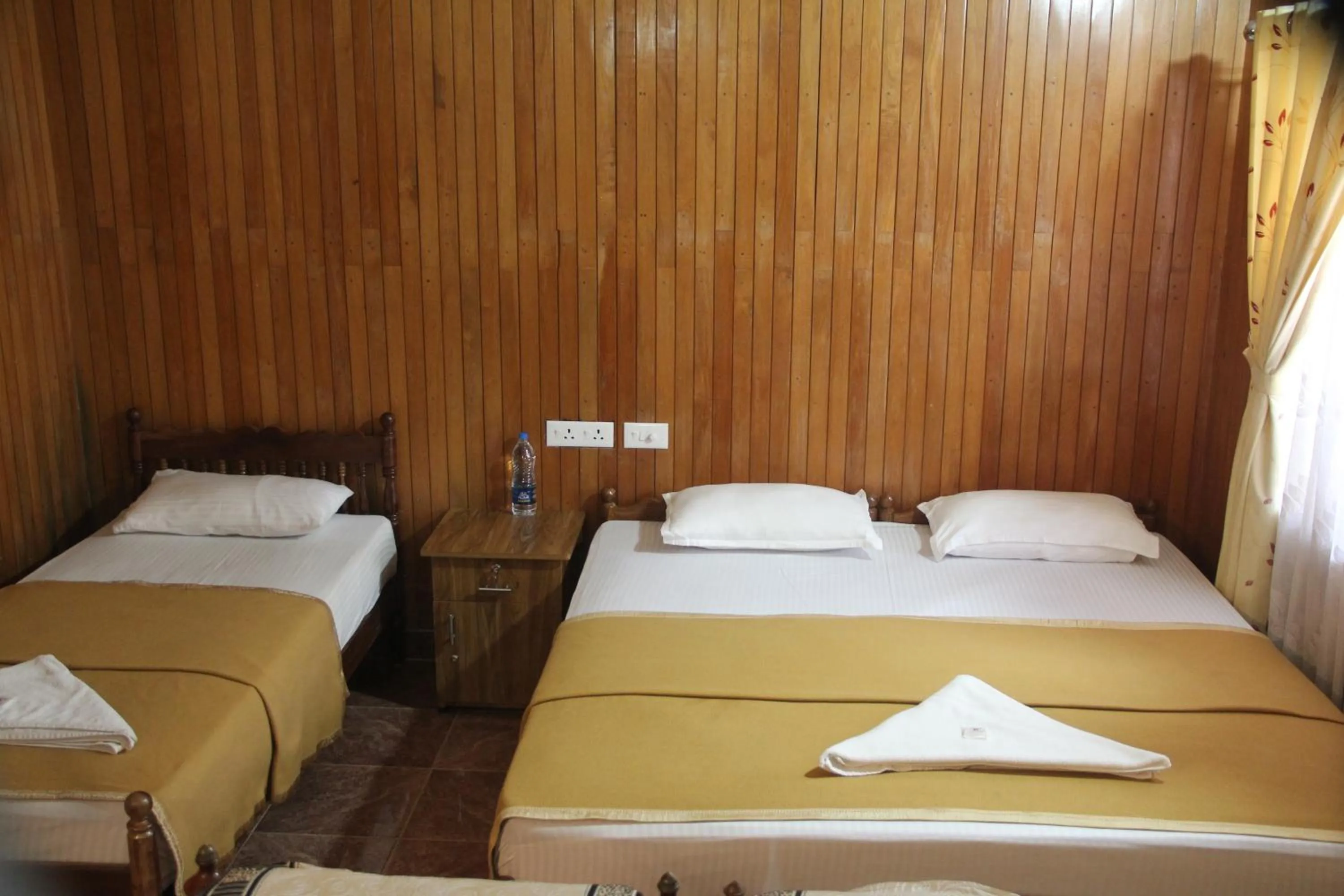 Bed in Lake Palace Family Resort Kumarakom