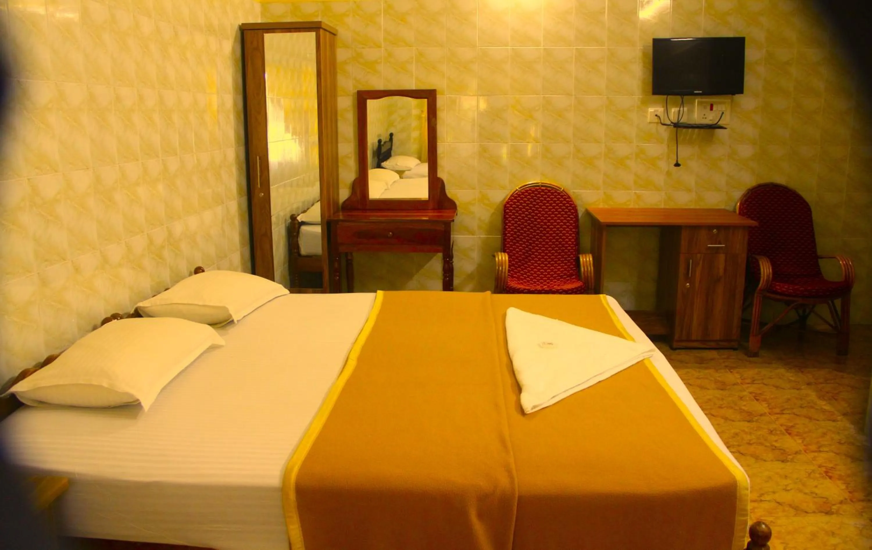 Bed in Lake Palace Family Resort Kumarakom