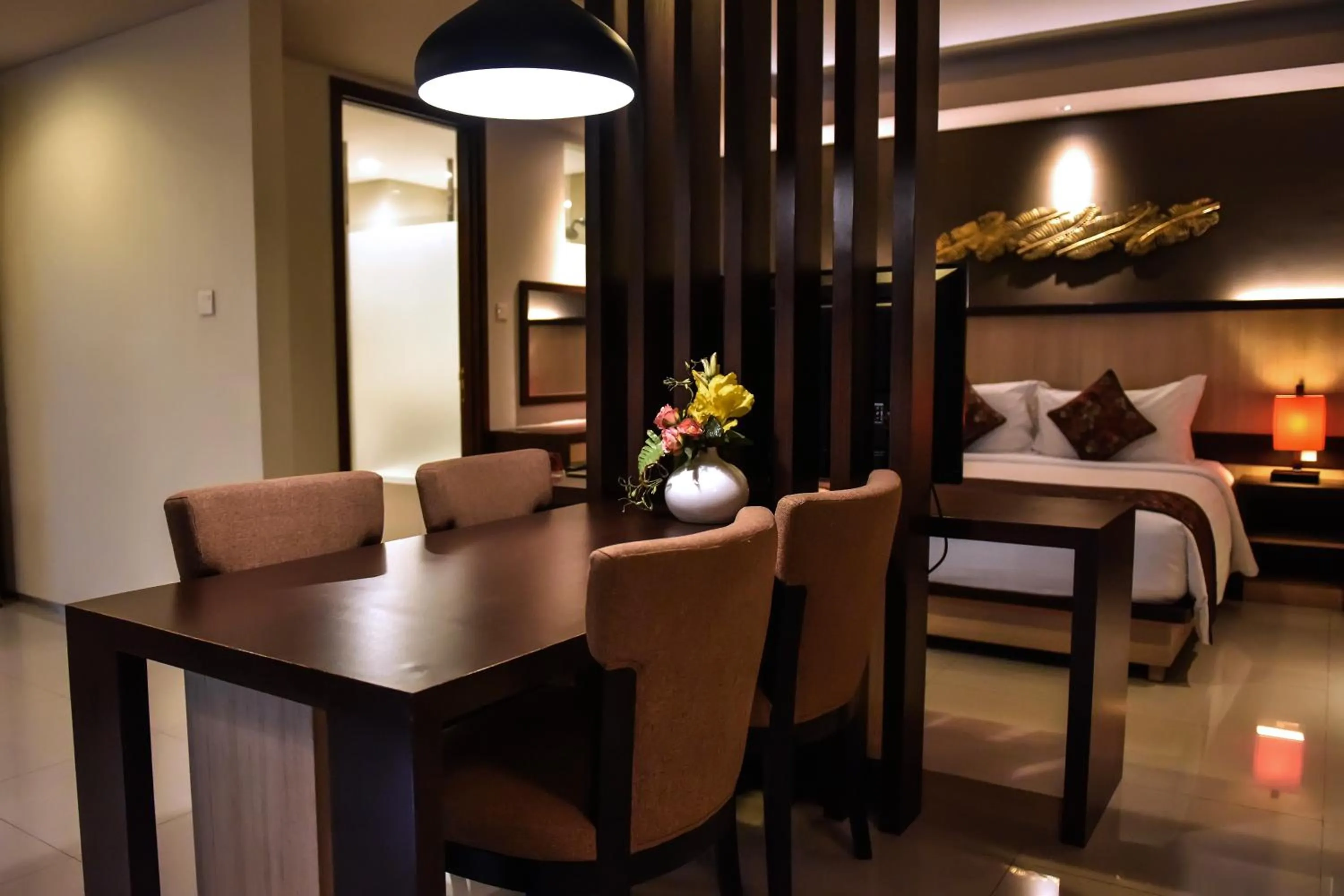Kitchen or kitchenette, Bed in The Kana Kuta Hotel