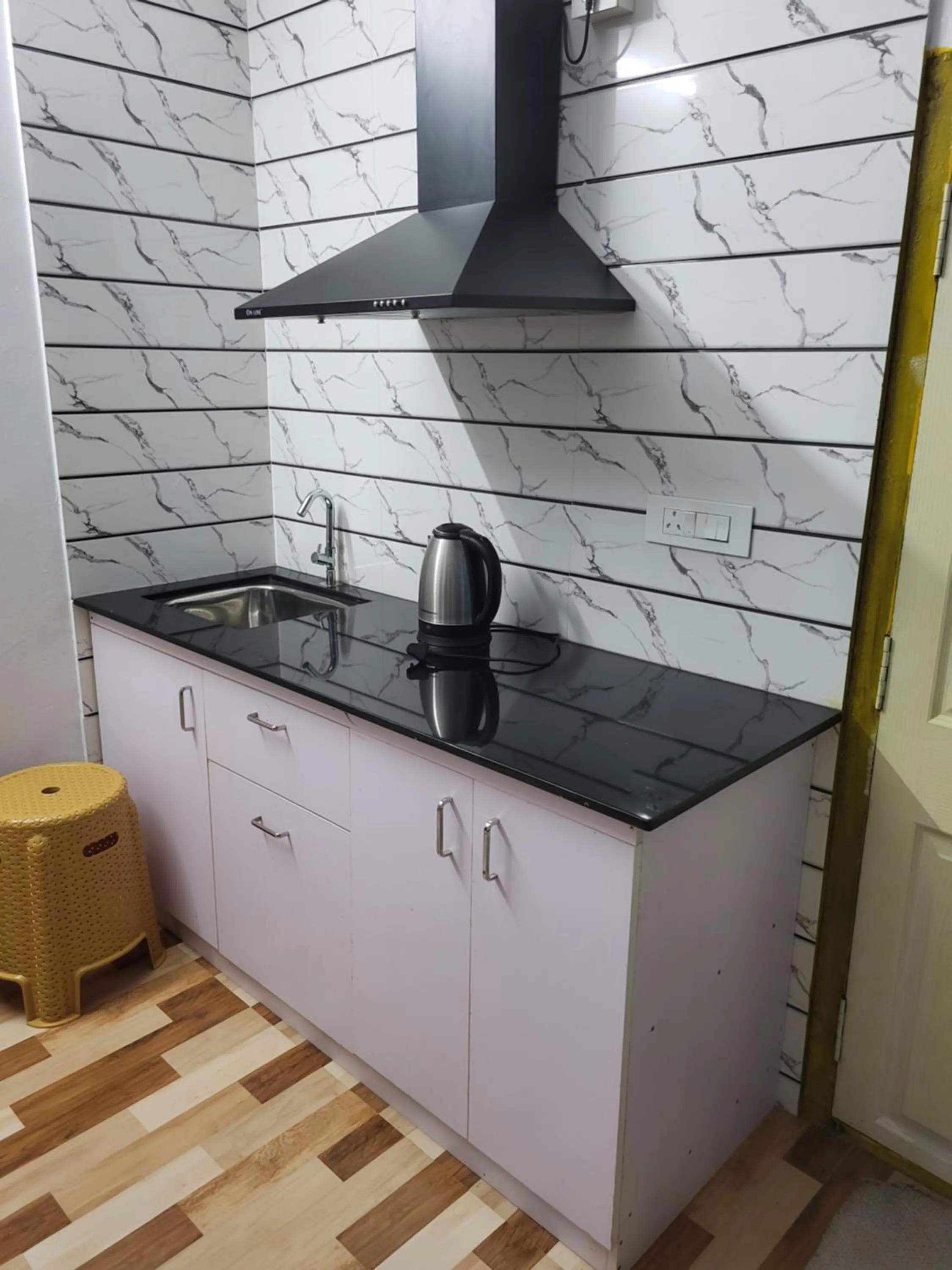 Kitchen or kitchenette in Ben's Villa Kannur !
