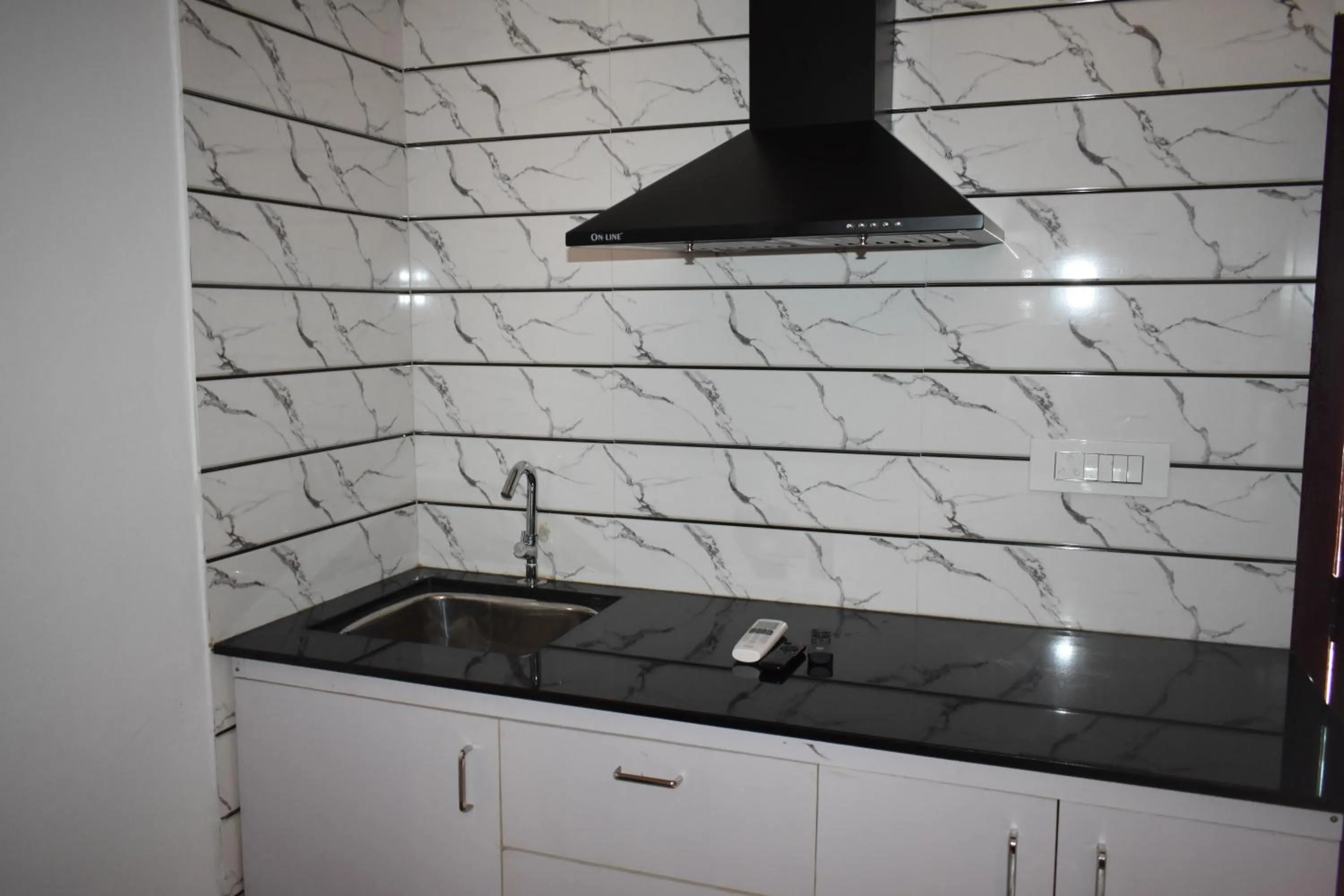Kitchen or kitchenette in Ben's Villa Kannur !