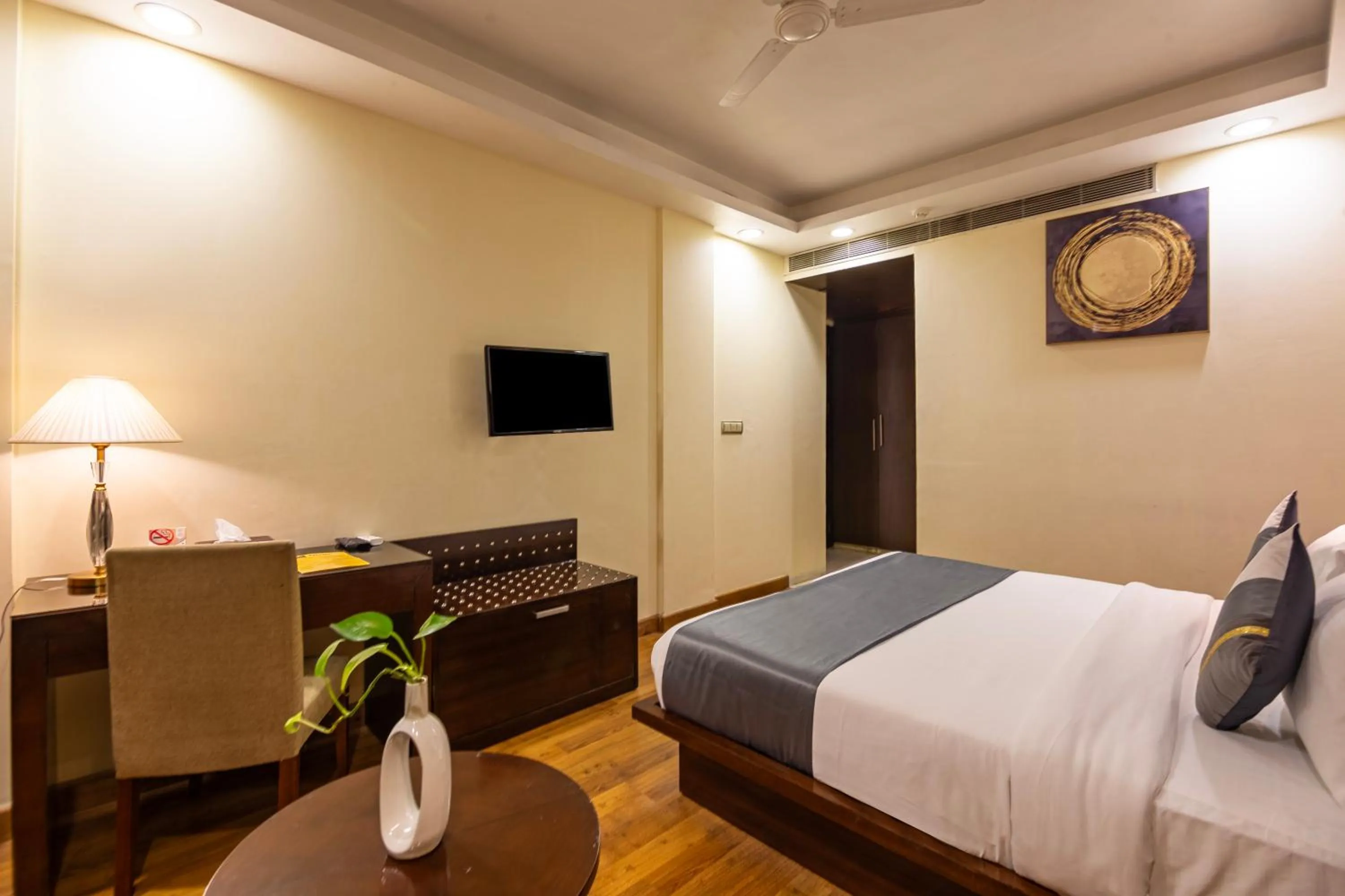 Bed in The Grand Orion - Kailash Colony