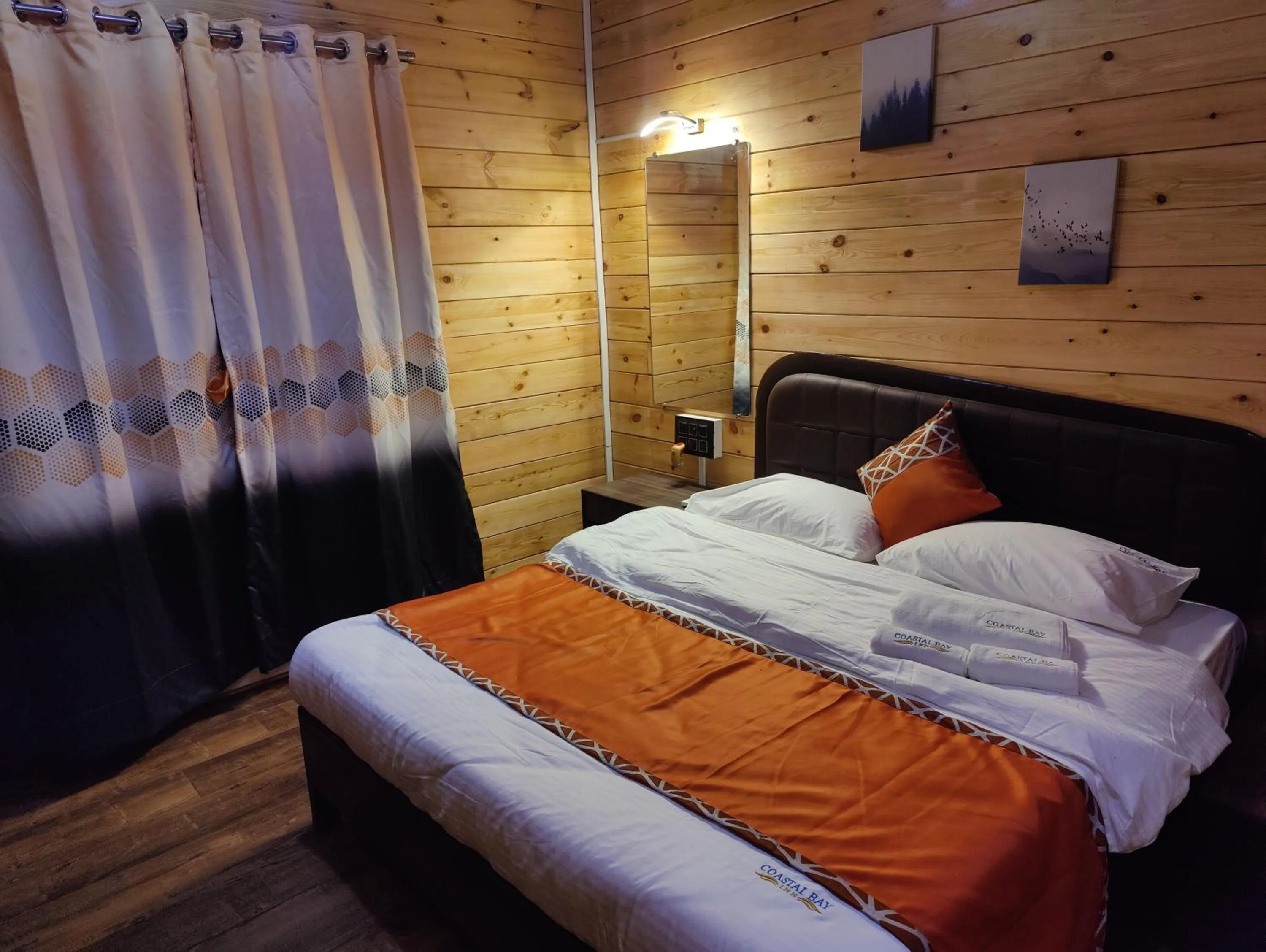 Bed in Coastal Bay Inn by Green Apple Stays