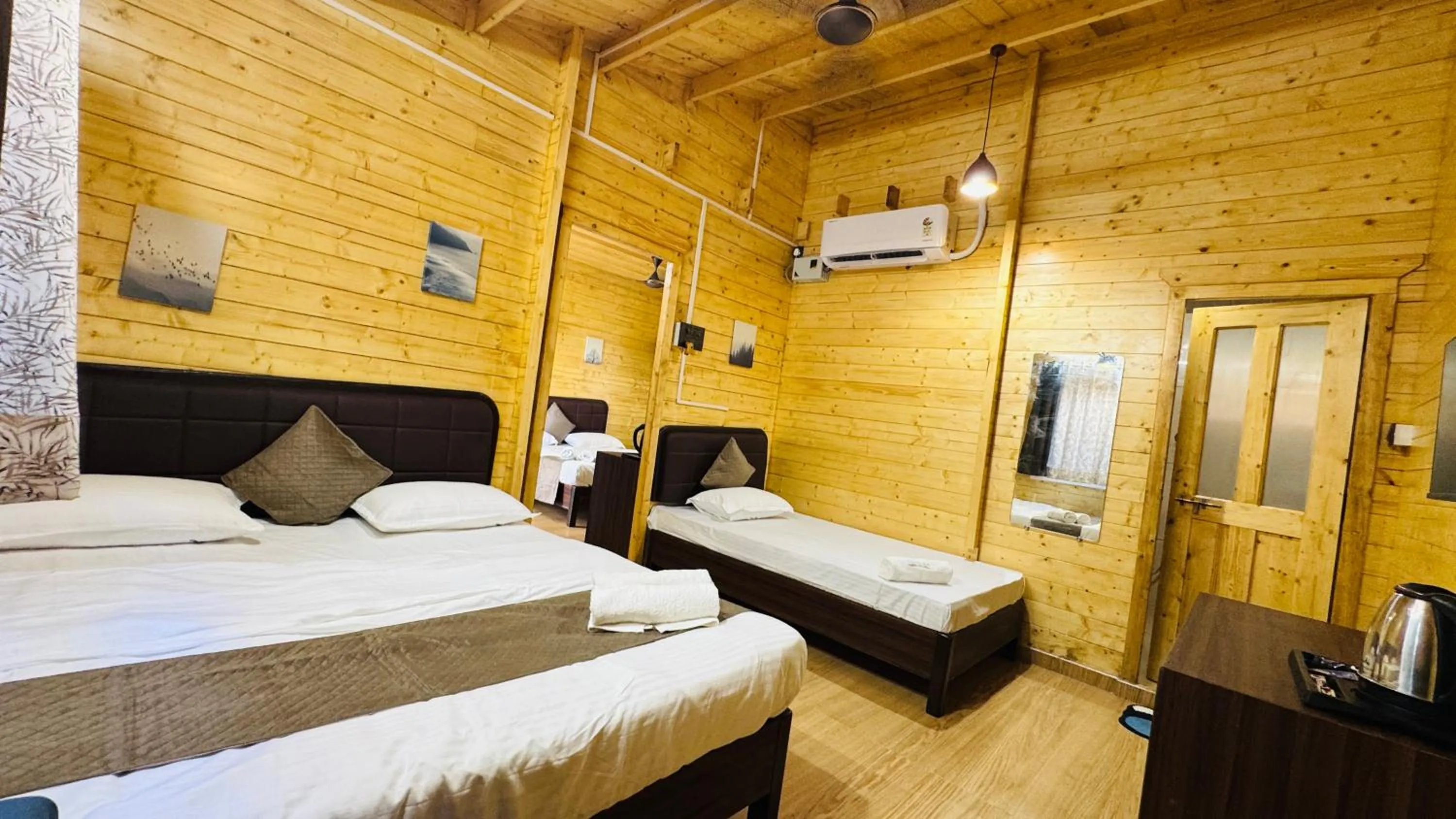 Bed in Coastal Bay Inn by Green Apple Stays