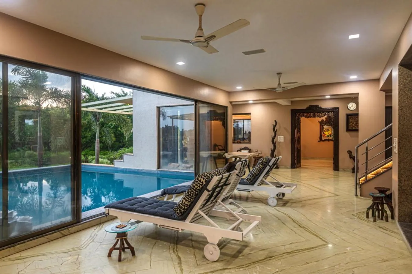 Seating area in SaffronStays Aura - 4BR luxury pool villa with gym, BBQ deck, lawns & indoor games near Kihim Beach