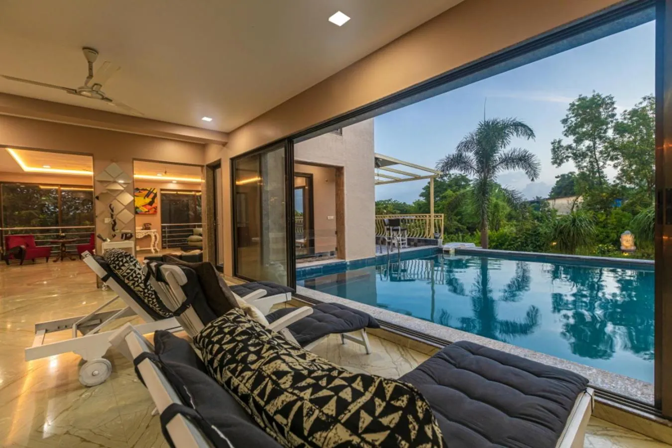 Seating area in SaffronStays Aura - 4BR luxury pool villa with gym, BBQ deck, lawns & indoor games near Kihim Beach