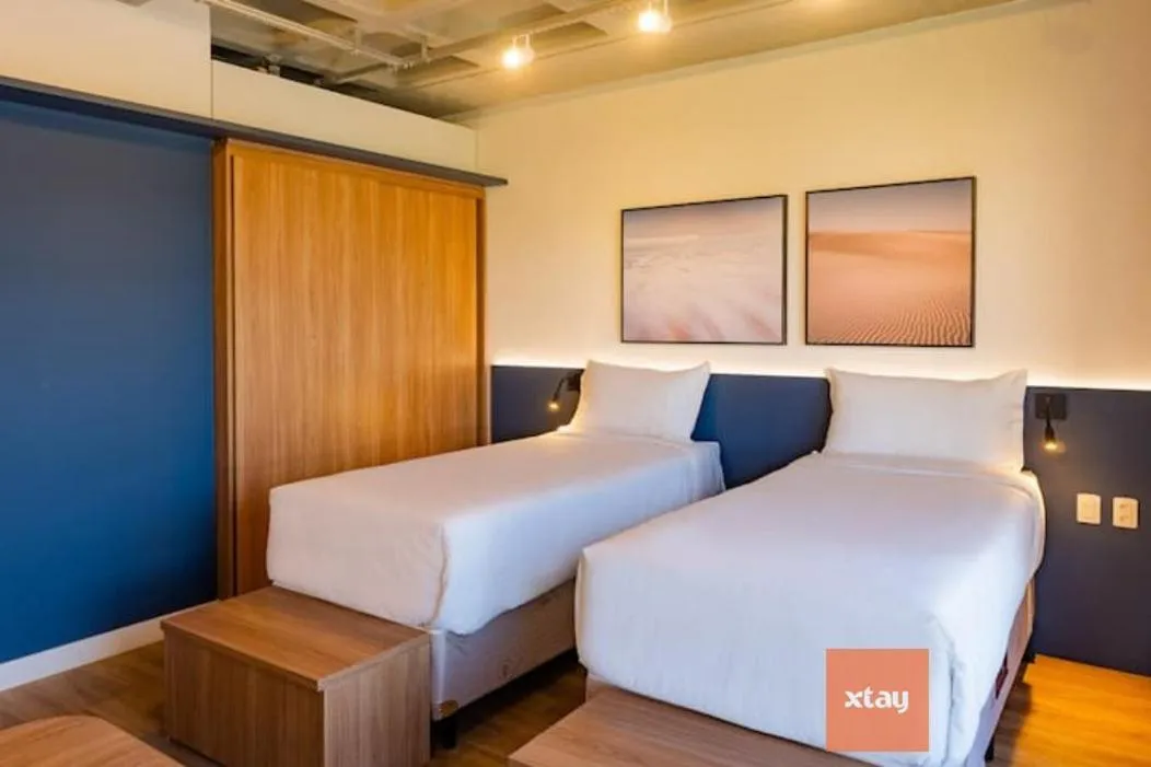 Bed in Atrium Studios by Xtay - Studio moderno em Pedra Branca - Caminhe até o Centro Empresarial e Unisul