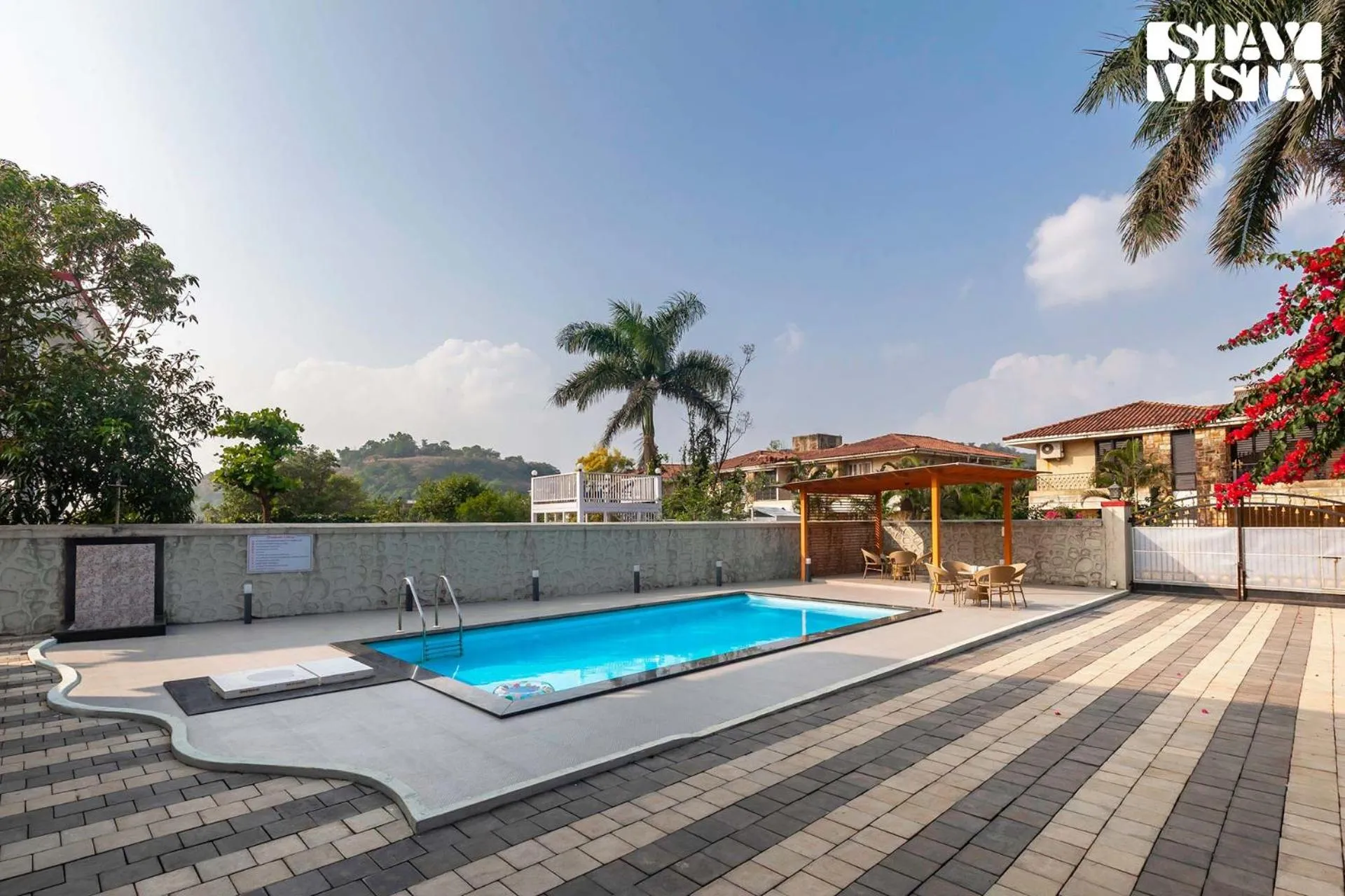 Swimming pool in StayVista's Brookvale Cottage - Dive into tranquility with pool view and gazebo