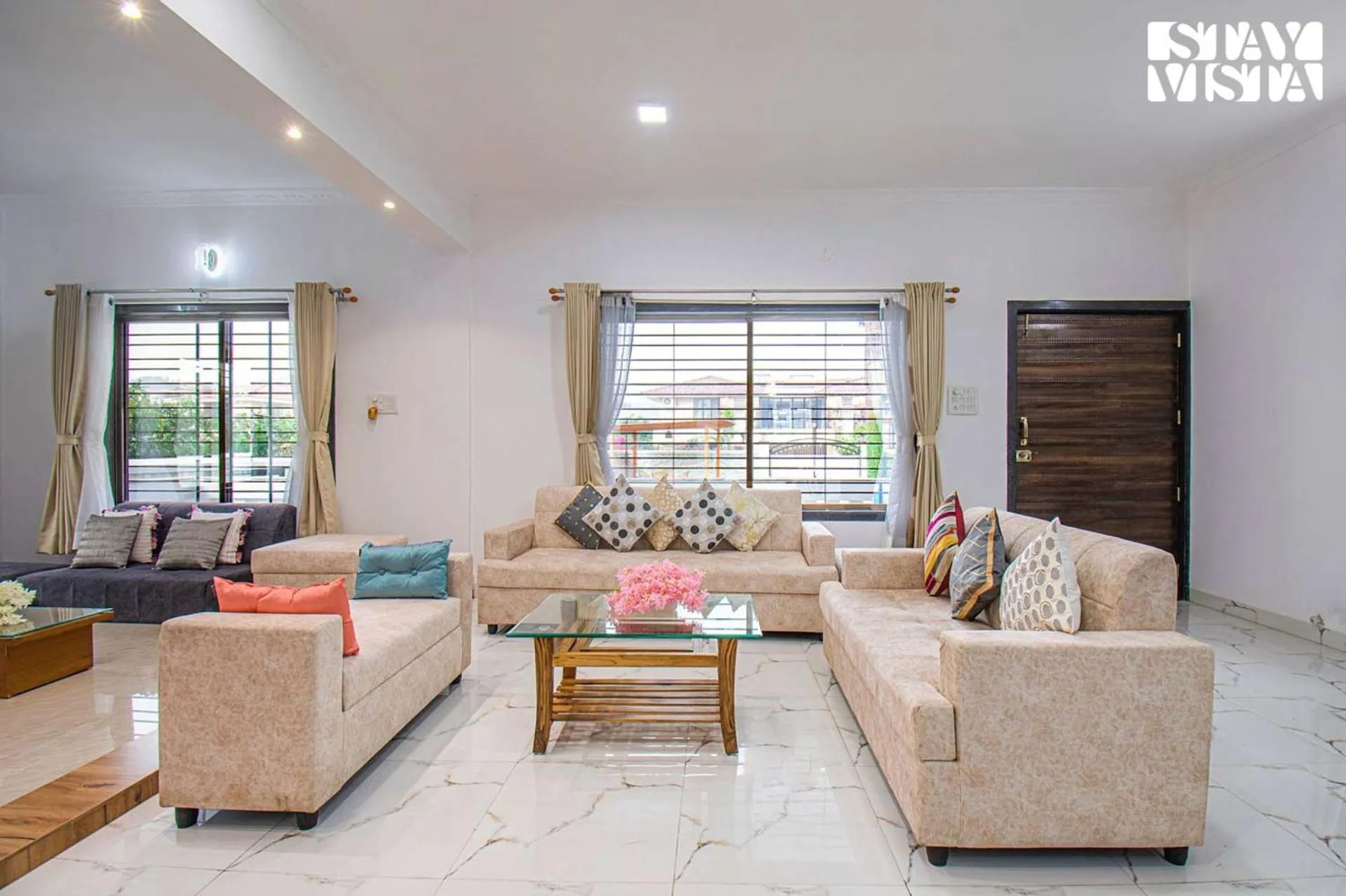 Living room in StayVista's Brookvale Cottage - Dive into tranquility with pool view and gazebo
