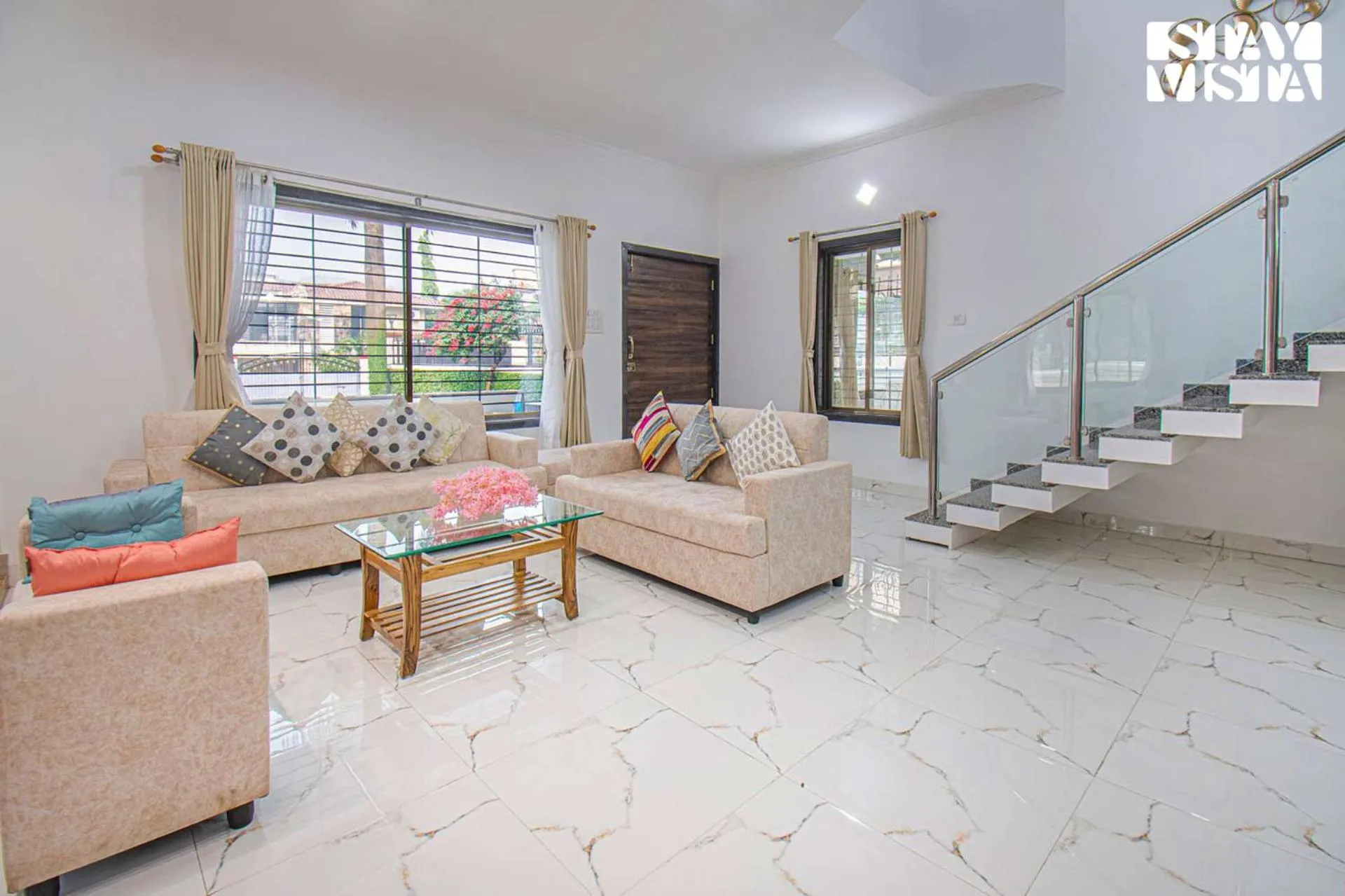 Living room in StayVista's Brookvale Cottage - Dive into tranquility with pool view and gazebo