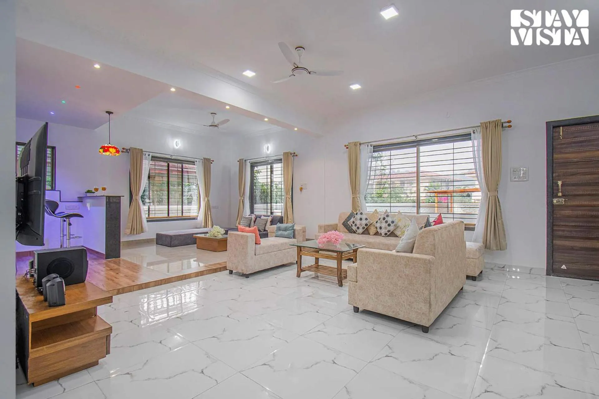 Living room in StayVista's Brookvale Cottage - Dive into tranquility with pool view and gazebo