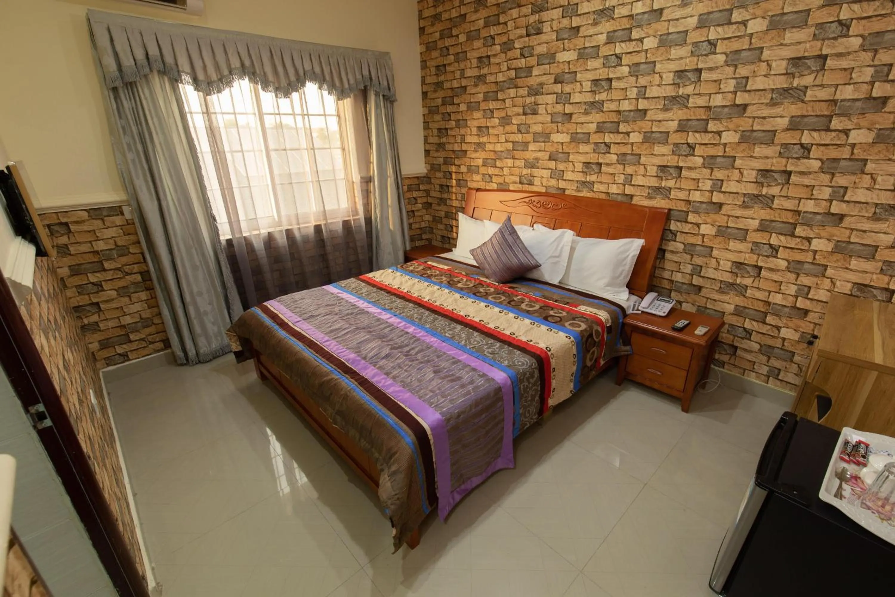 Bed in Amazing Grace Hotel & Suites