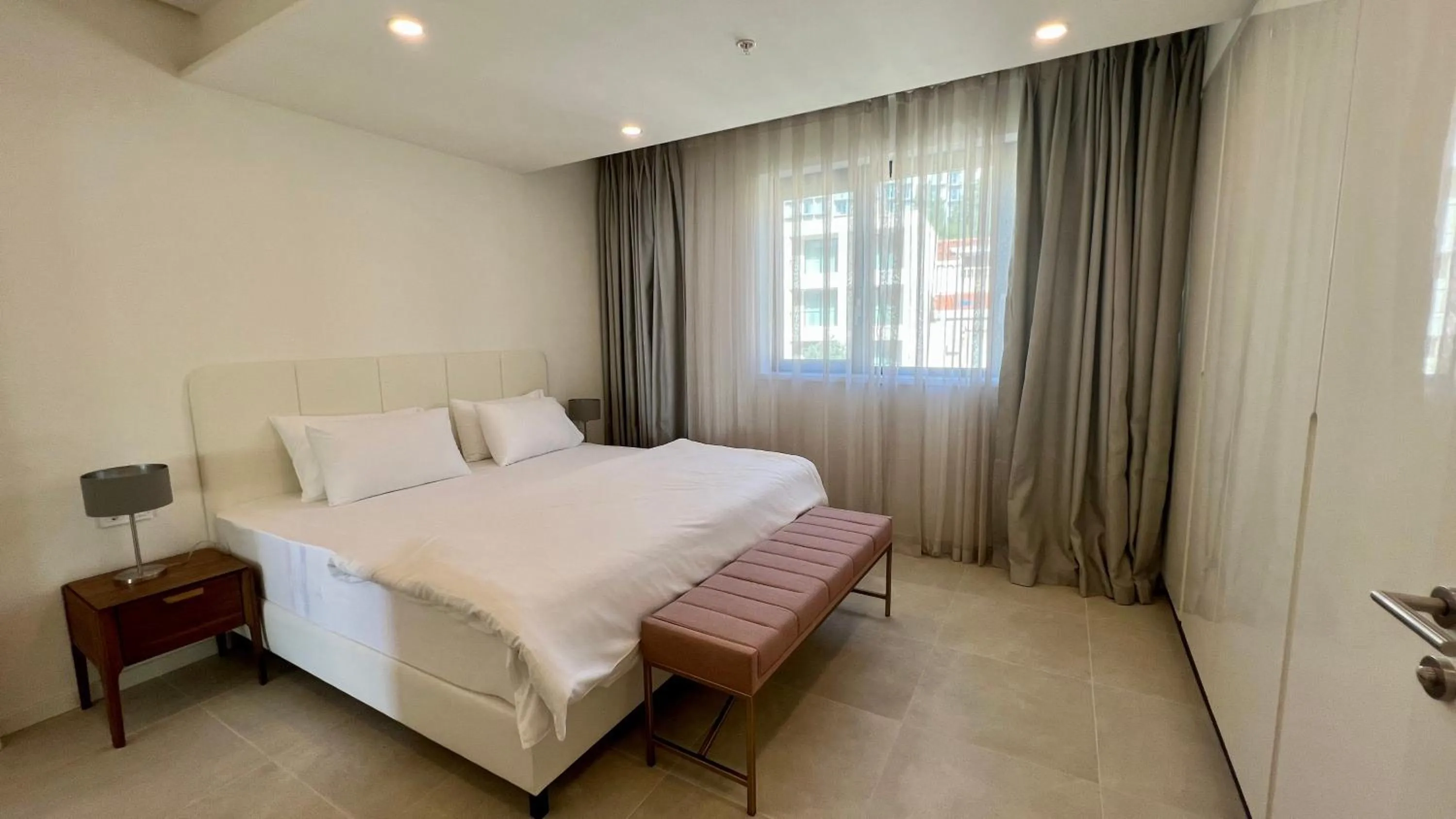 Bed in Sunraf Luxe Apartments