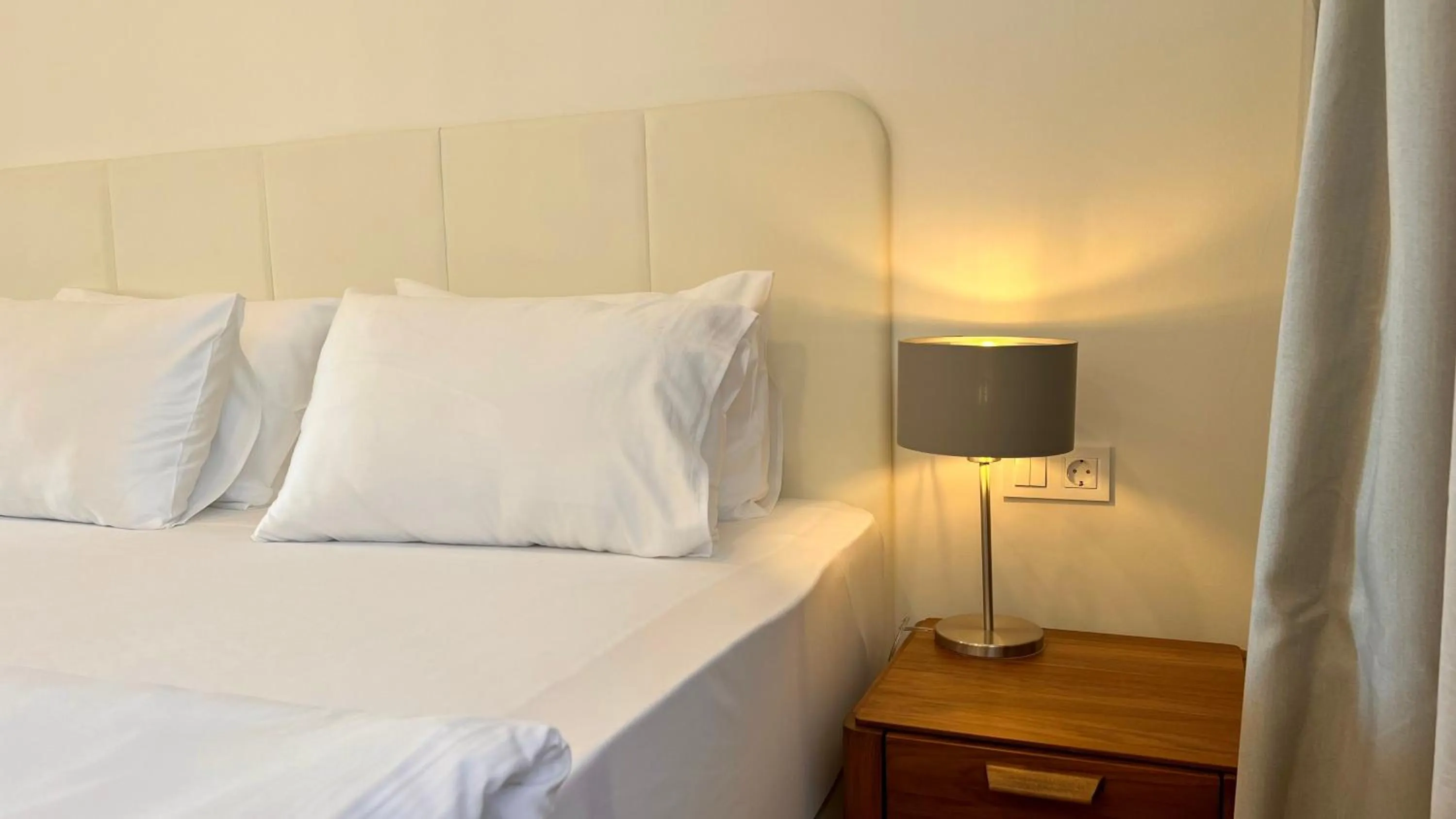 Bed in Sunraf Luxe Apartments