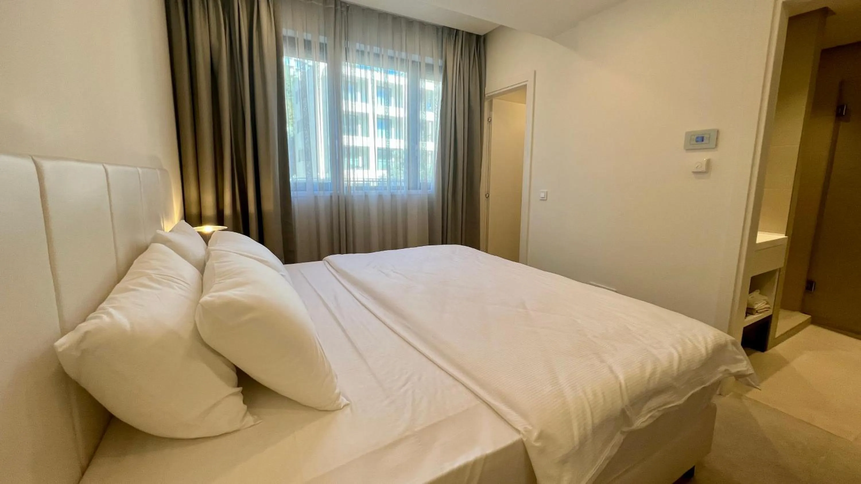 Bed in Sunraf Luxe Apartments