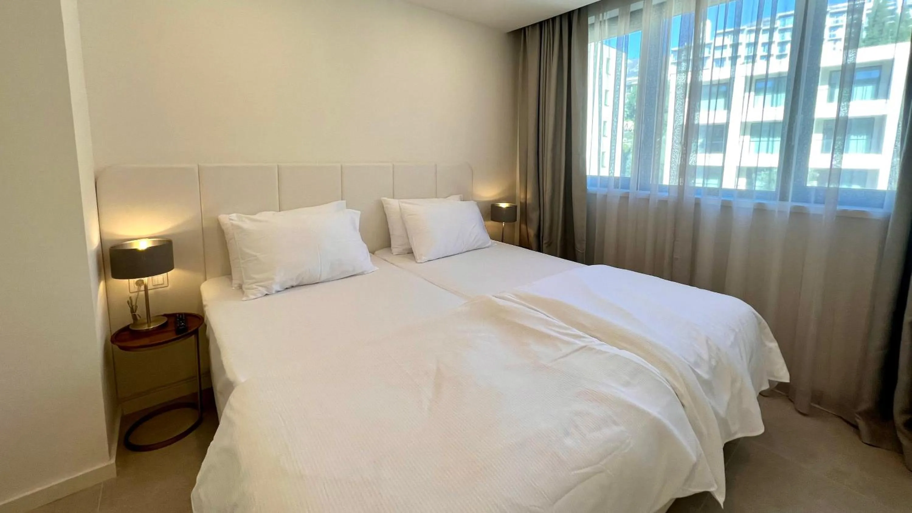 Bed in Sunraf Luxe Apartments