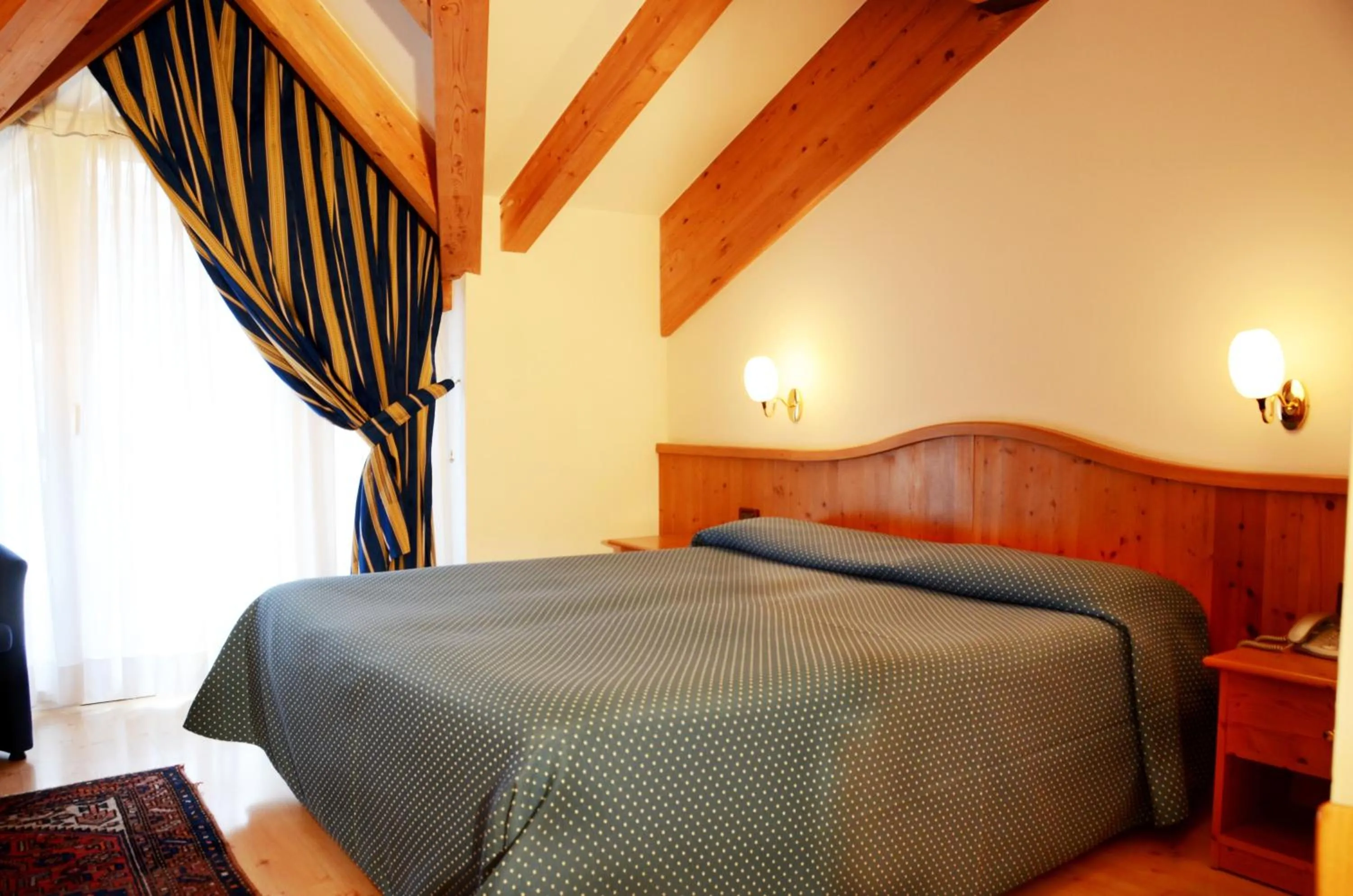 Bed in Hotel Dolomiti